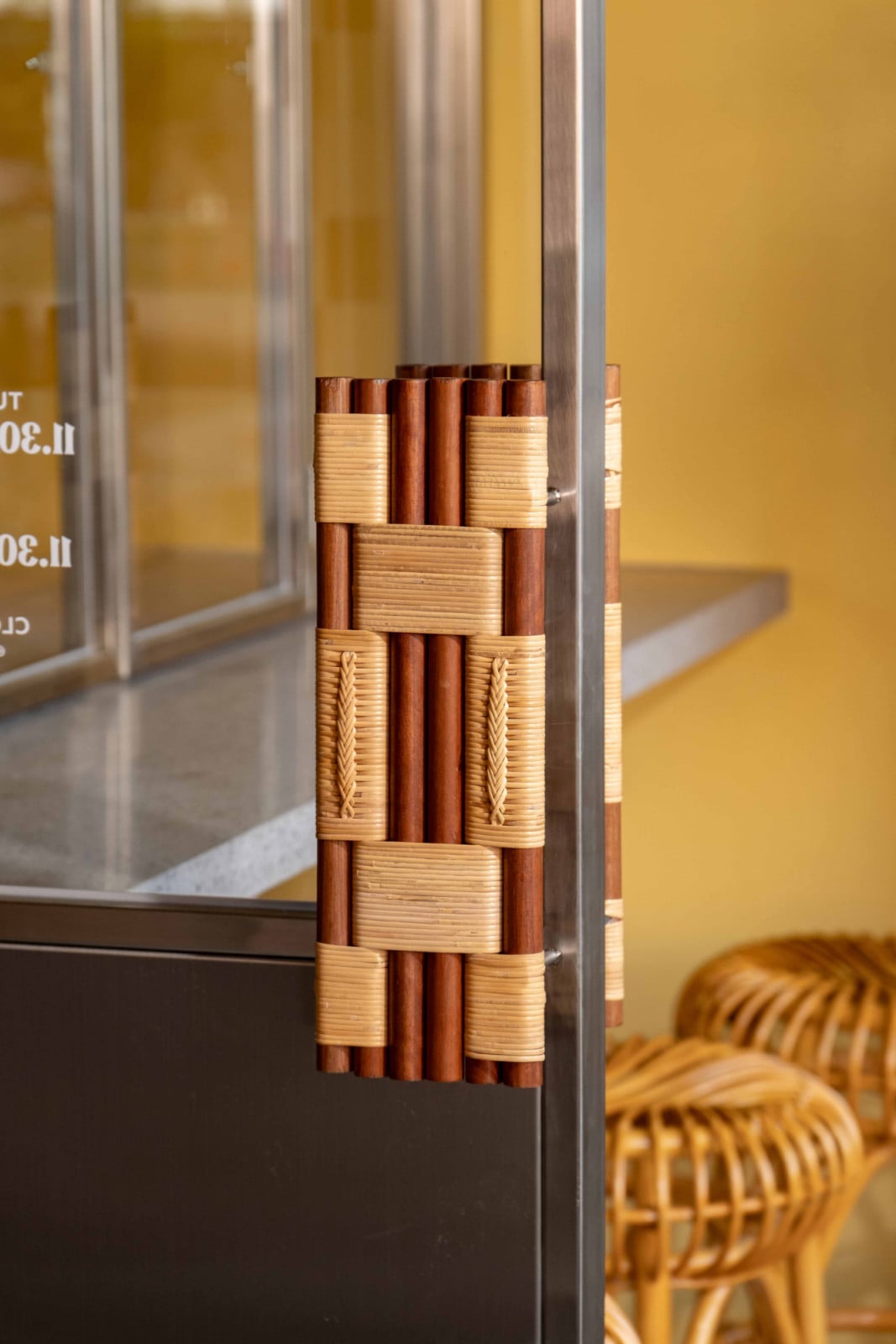 A close-up of a rattan door handle at The Coconut Club at New Bahru
