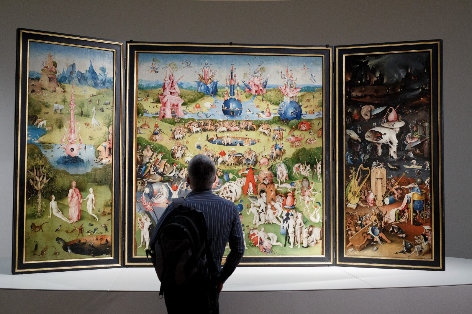 MADRID, SPAIN - MAY 27: A man looks at of 'The Garden of Earthly Delights Triptych' by the Dutch painter Hieronymus Bosch during a press preview of the 'El Bosco' 5th Centenary Anniversary Exhibition at El Prado Museum on May 27, 2016 in Madrid, Spain. The Prado Museum will host the exhibition celebrating the work of Dutch painter Hieronymus Bosch to mark 500 years since his death in 1516. It consists of sixty-five works of art loaned by collections based all over the world, and will be open to the public