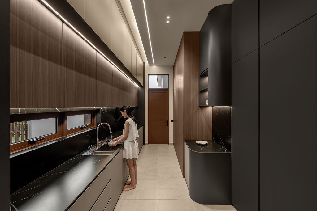 The wet kitchen corridor features micro-cement walls and concealed linear lighting