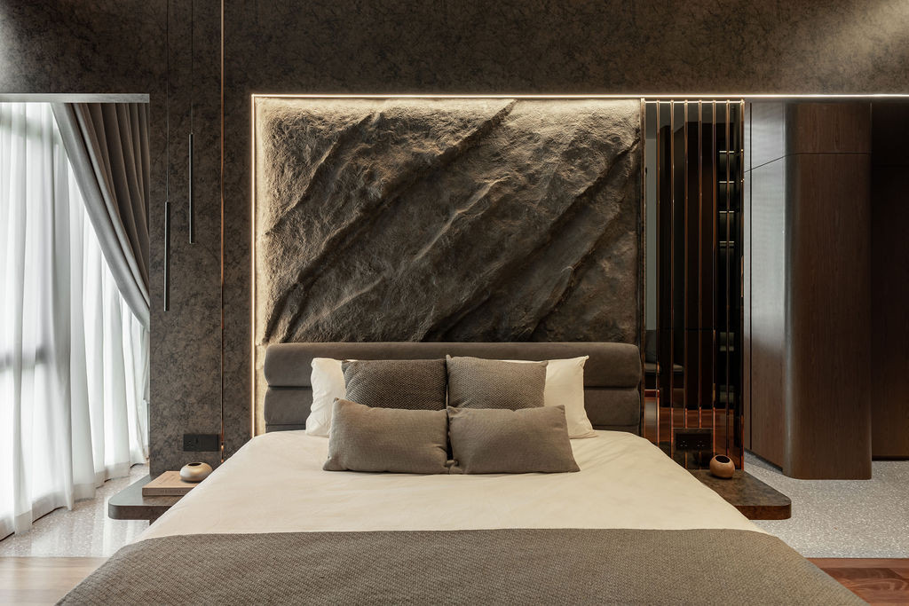 A backlit textured stone feature wall anchors the bedroom with dramatic gradient lighting