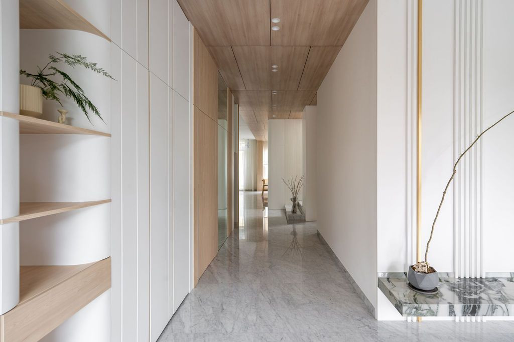 Warm wood finishes add tactile comfort, while marble accents and brass details introduce understated luxury (Photo: Bricksbegin)