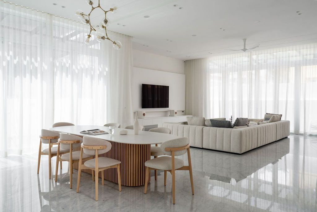 The open-plan living, dining, and dry kitchen areas are designed with high ceilings and generous spatial proportions (Photo: Bricksbegin)