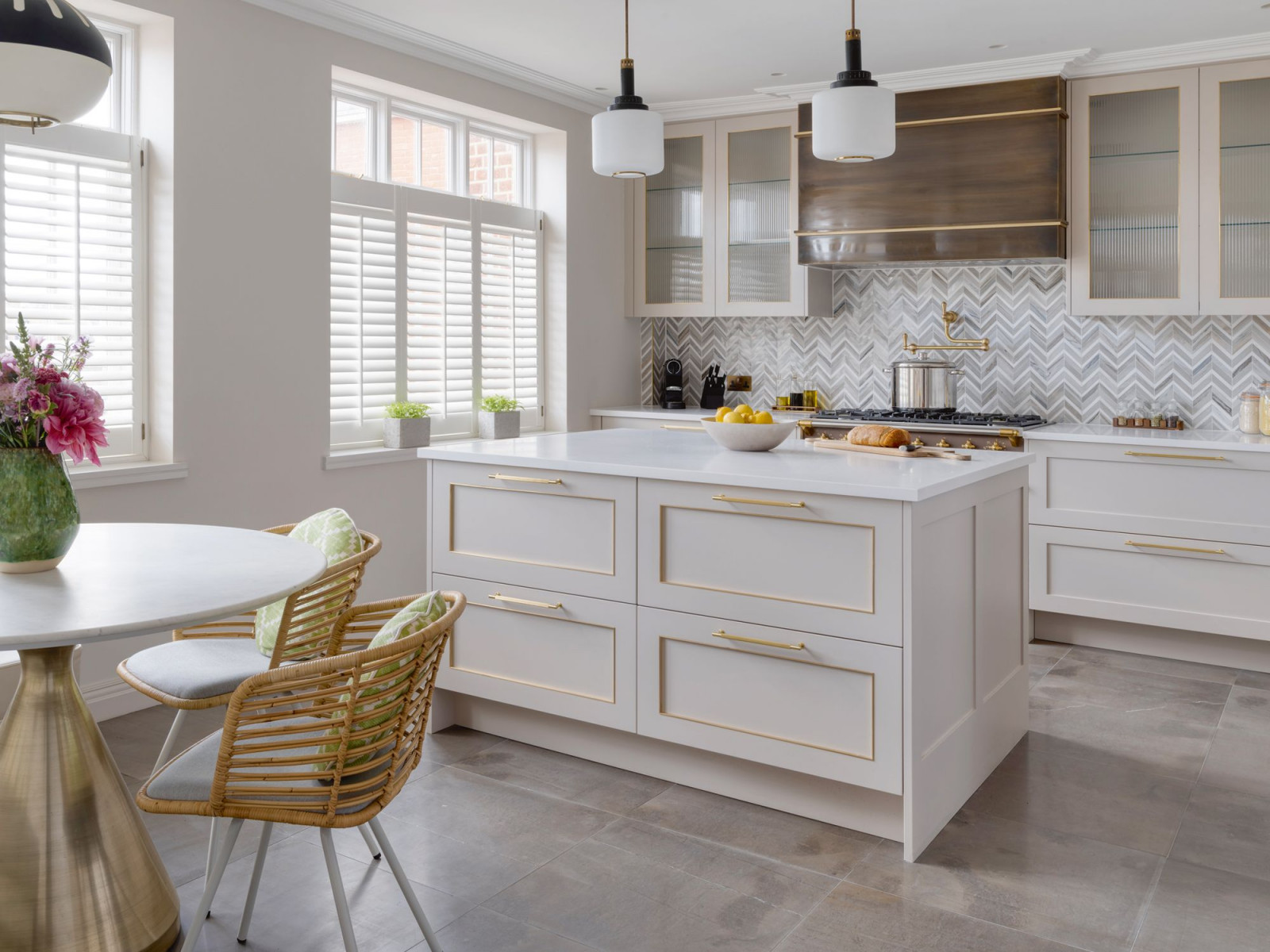 The kitchen and secondary dining area maintain a soft, earthy palette with marble flooring (Photo: Rich Gooding)