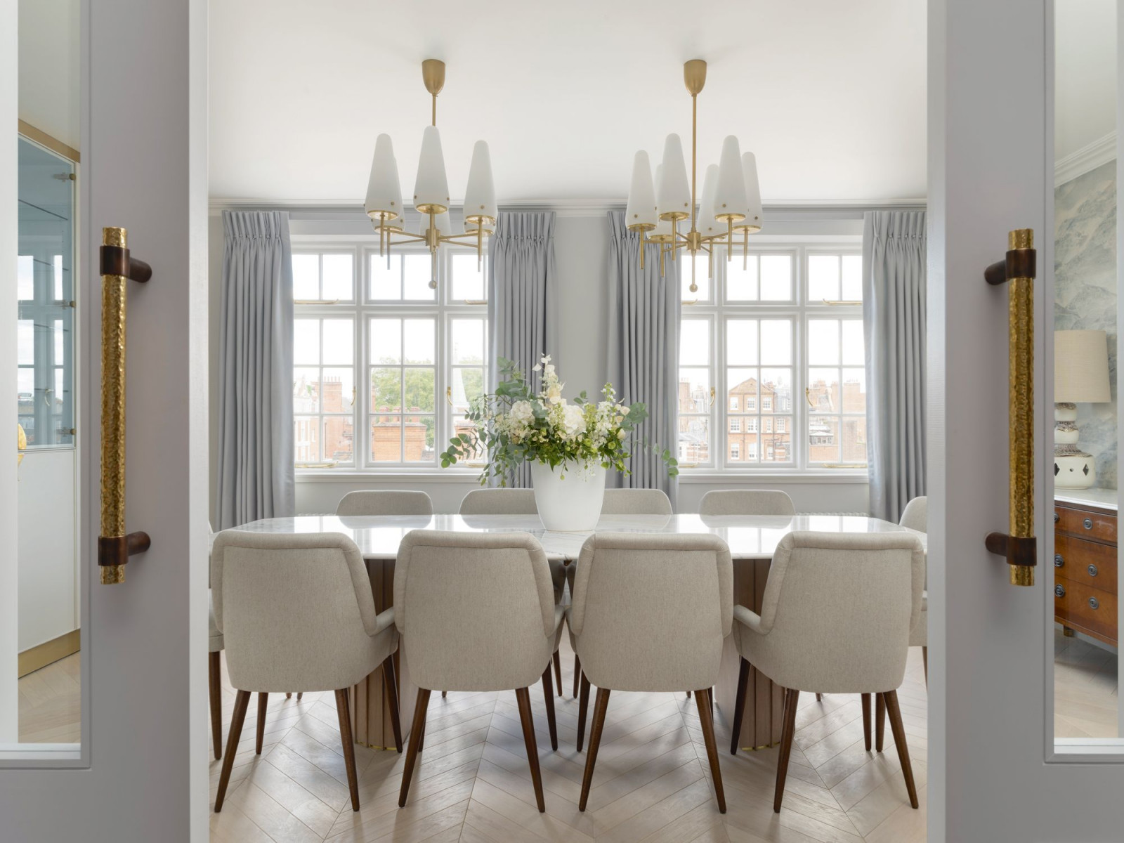The formal dining room with Hans-Agne Jakobsson chandeliers create a light, ethereal ambience (Photo: Rich Gooding)