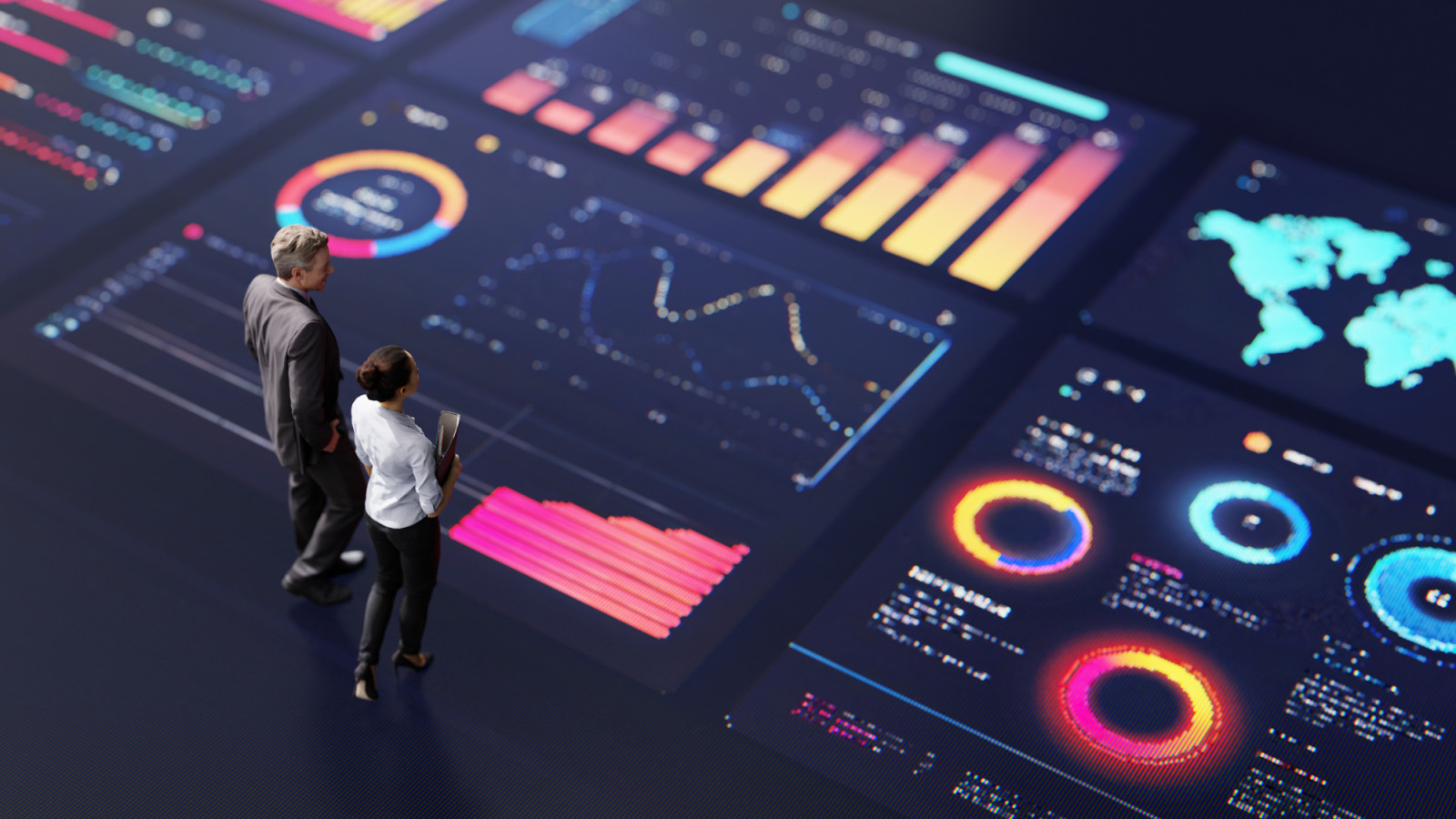 Abstract people standing on a large digital screen, analysing interactive data visualisations and charts for strategic planning. Representing teamwork, technology, and data-driven decision making in a corporate environment. (photo: sankai / Getty Images)