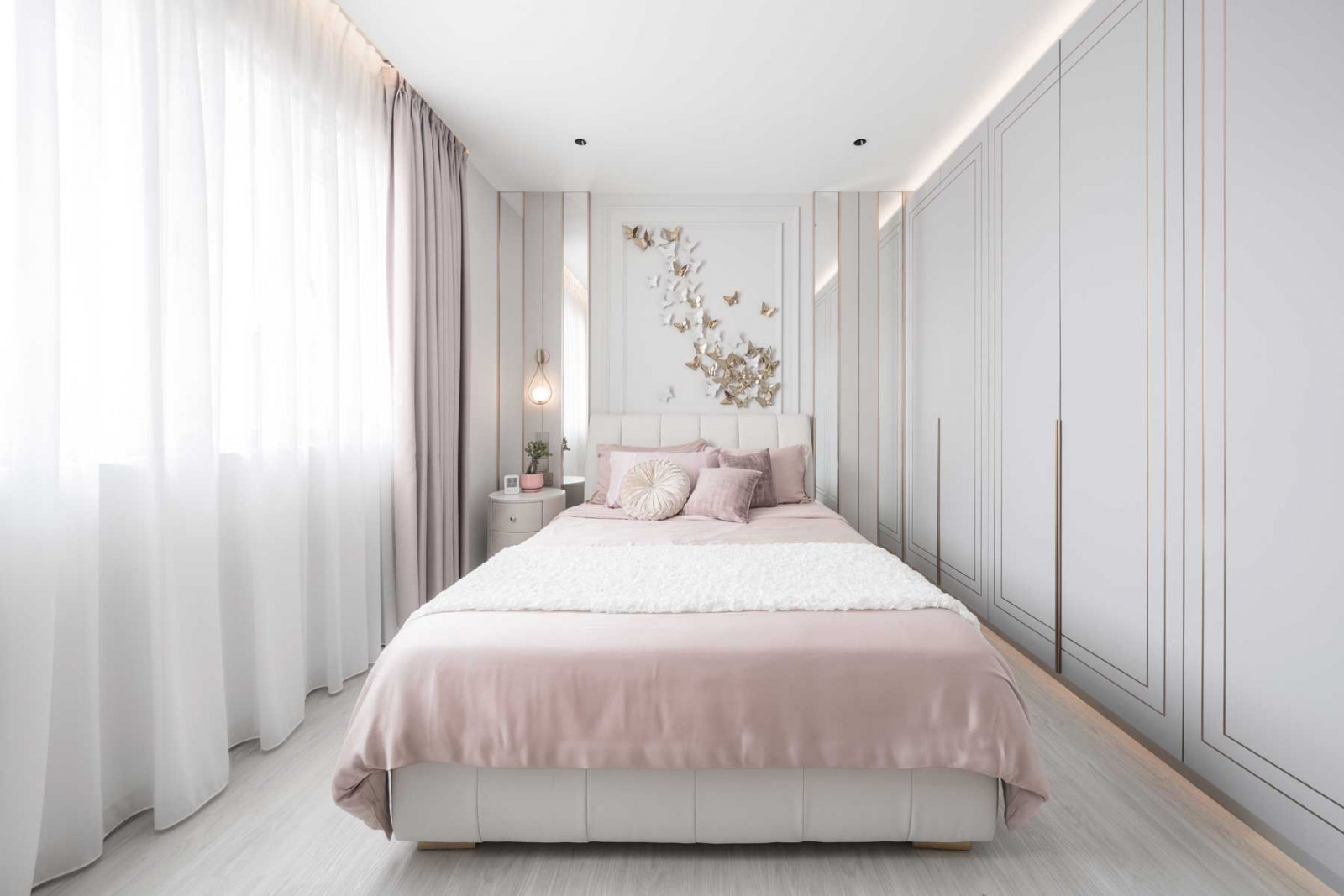Summerhaus D’zign Serangoon terrace house - soft, pink textiles add femininity to the daughter’s bedroom, where an installation of white and gold butterflies takes flight above the headboard