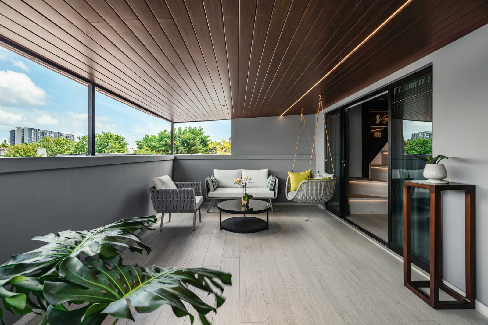 Summerhaus D’zign Serangoon terrace house - one of the house’s many balconies, furnished with outdoor sofas and a swing seat