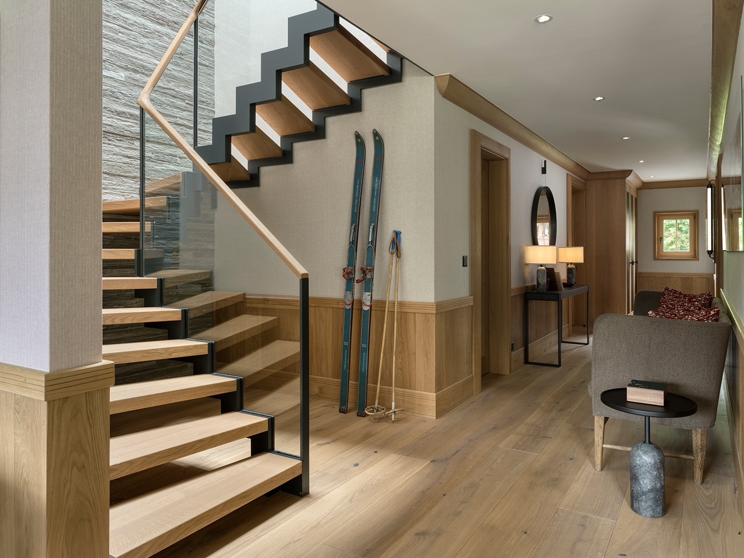 The stairway and entrance of the Klosters, Switzerland family chalet, designed by Tollgard Studio