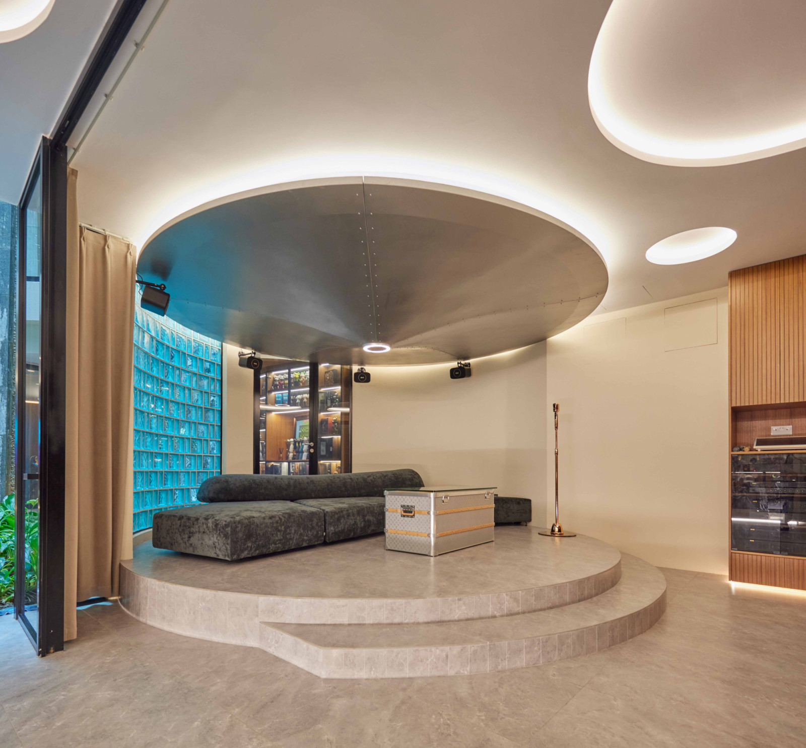 An Edra On the Rocks sofa and the Coffee Funnel sculpture anchor this circular corner of the bungalow’s entertainment room