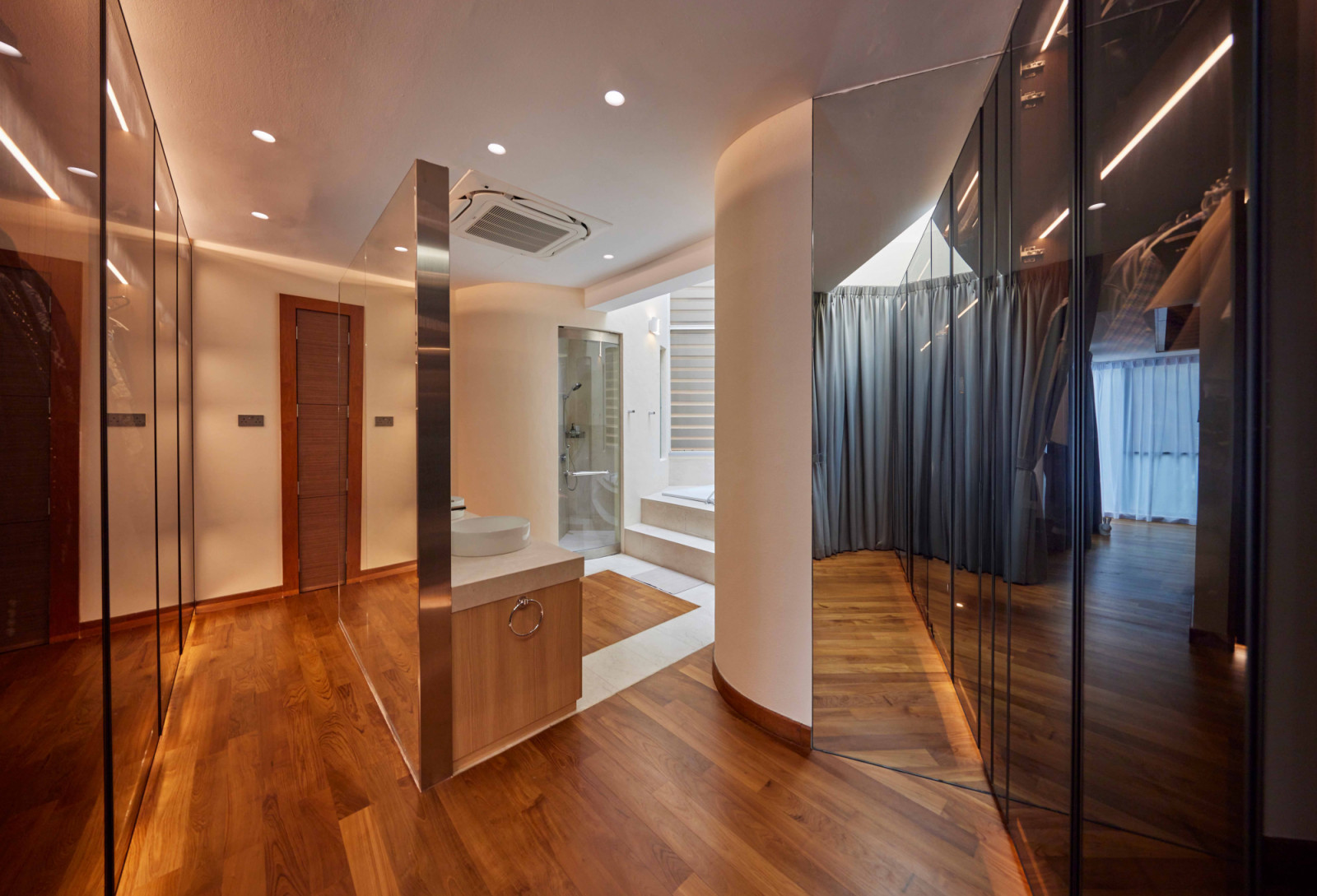 Expansive mirrored panels in the master bathroom amplify light and the feeling of spaciousness