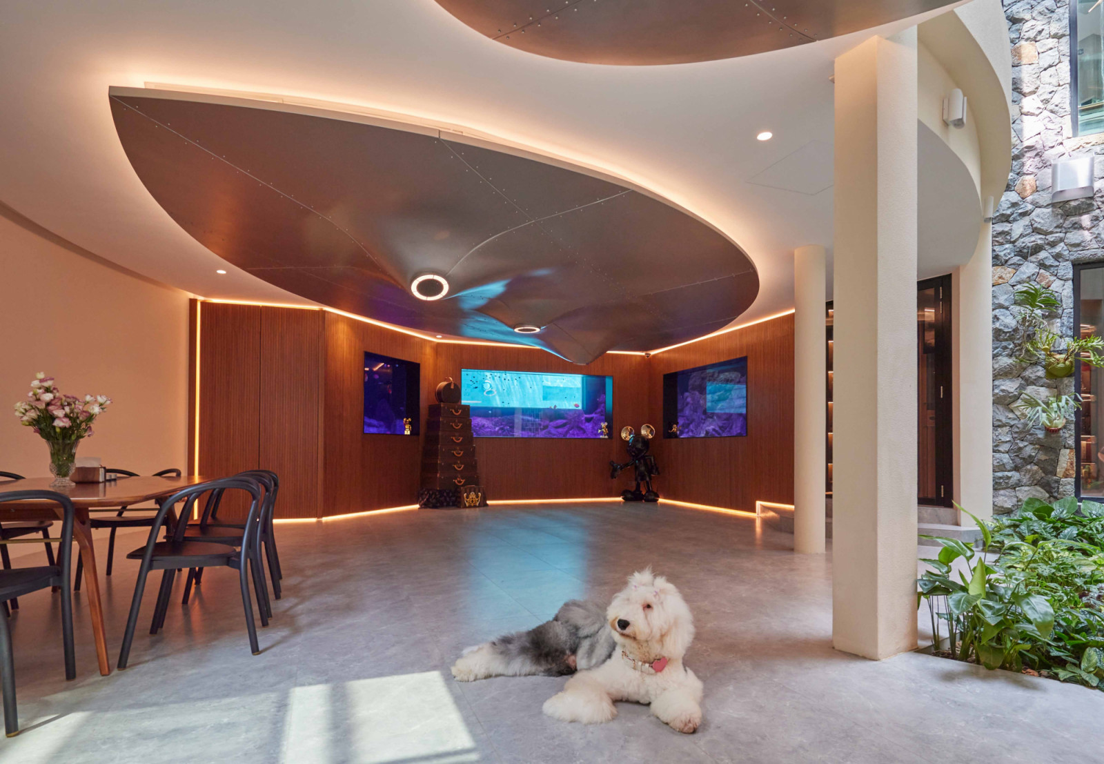 The bungalow’s multipurpose family hall showcases the Cow Udder installation and a dramatic fish tank