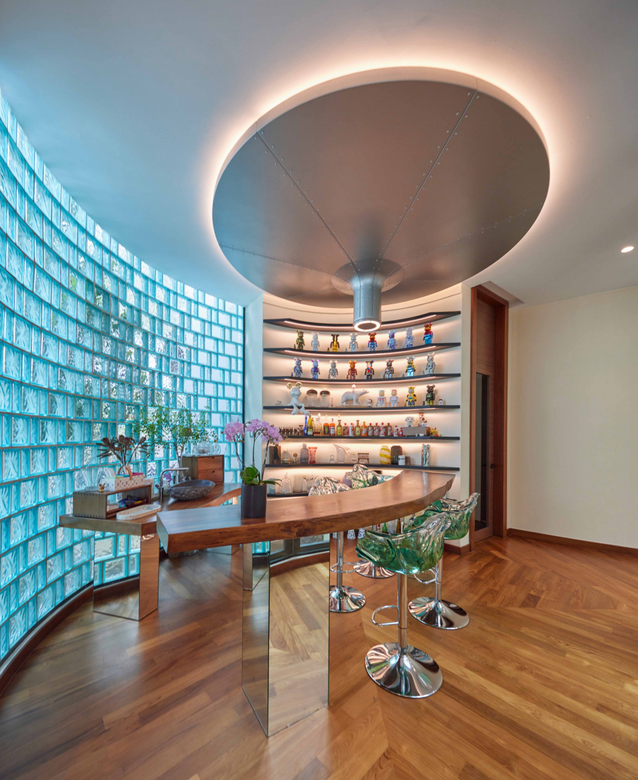 Beneath the Oil Funnel, a circular room clad in blue glass blocks serves as a study