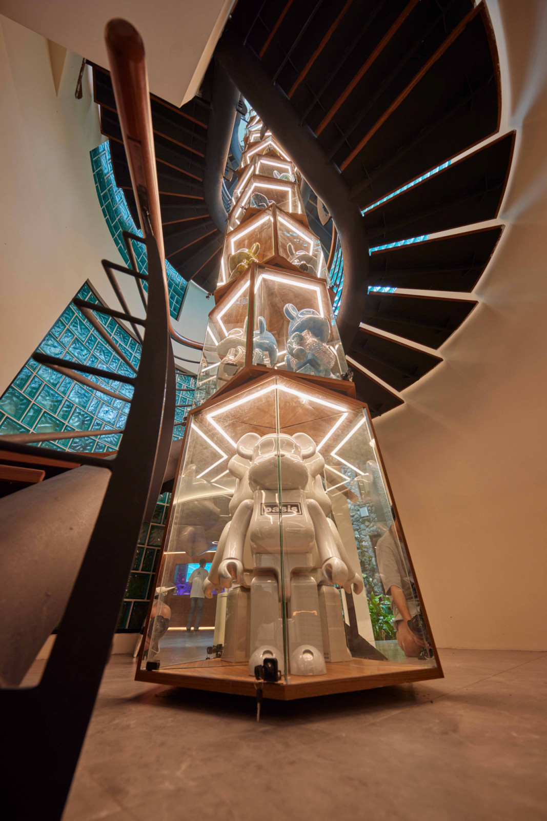 At night, the rotating Bearbrick display boxes are carefully lit, adding a sense of drama