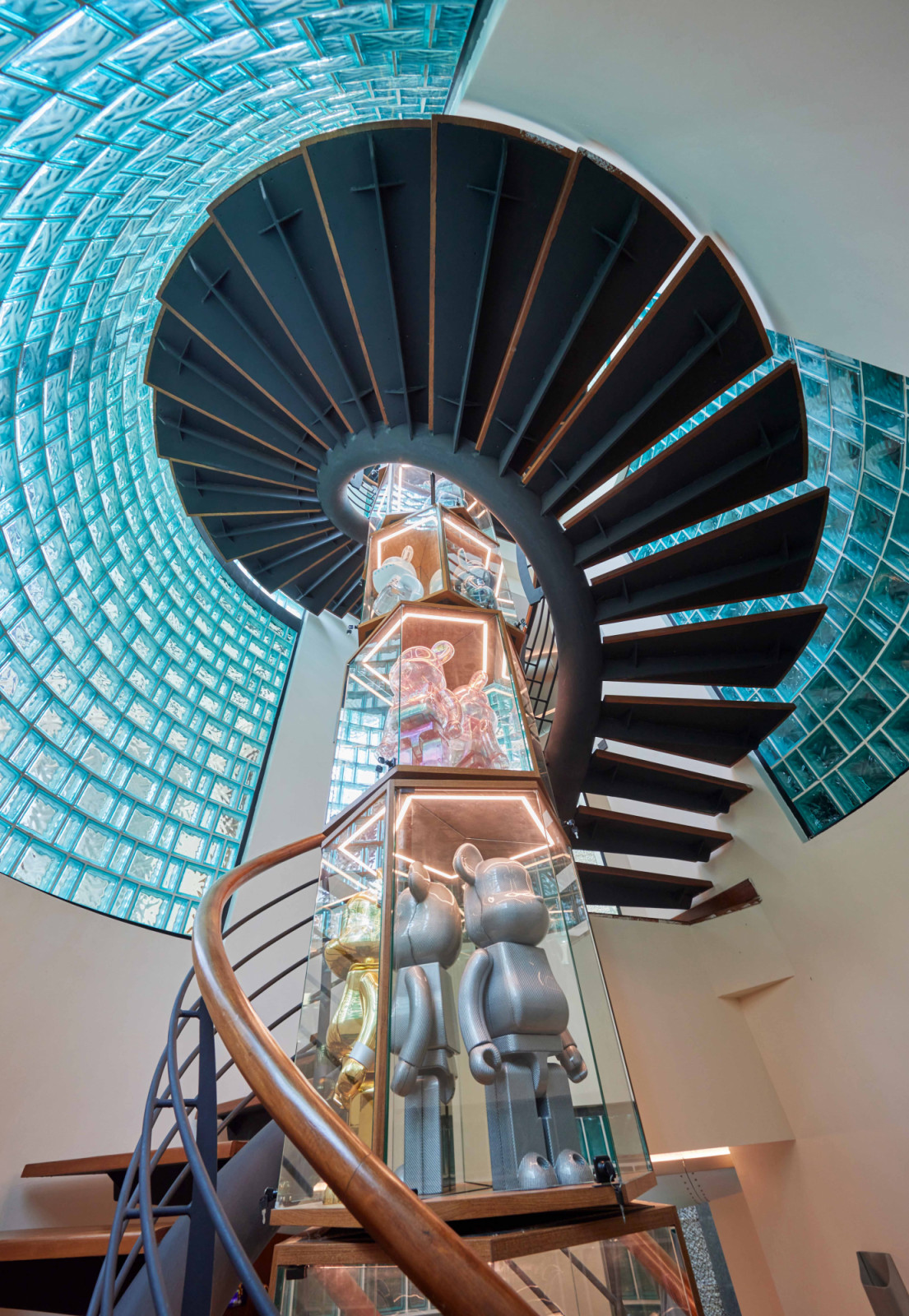 This spiral staircase links all four levels of the home, its centre ingeniously designed as the Tower, a rotating display for Bearbricks