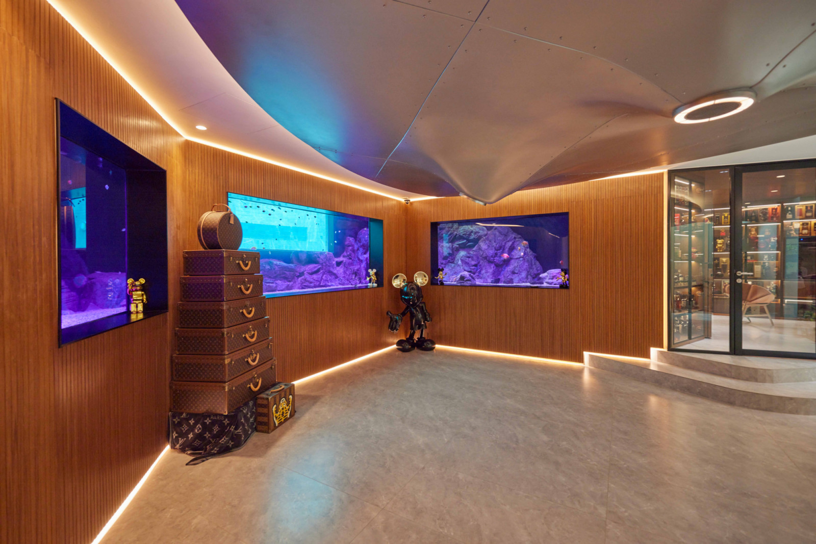 The basement’s multifunctional family room is layered with precious collectibles and installations