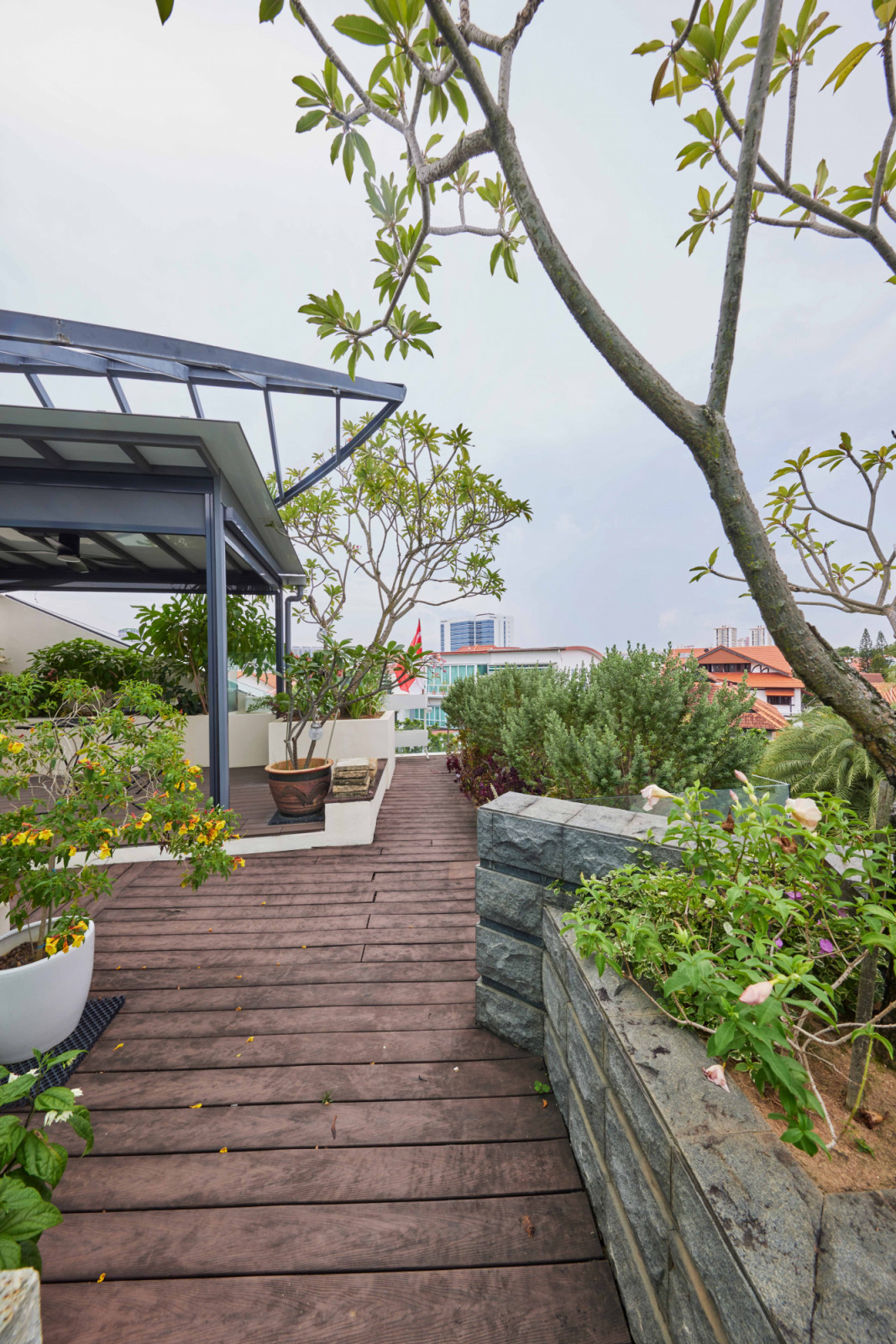 Lined with lush planters, the bungalow’s rooftop offers a verdant outdoor escape