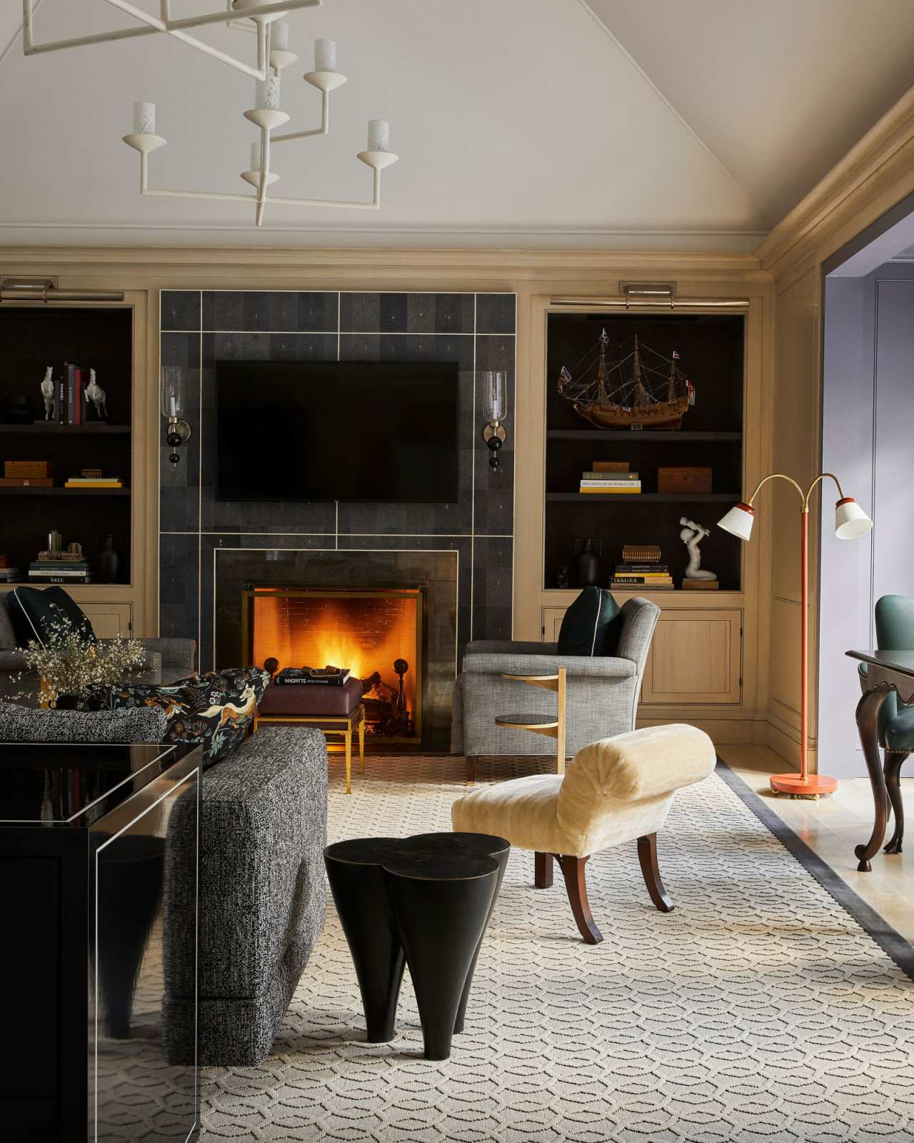 The fireplace roaring in the living room of an Ontario, Canada mansion renovated by Sabrina Albanese Interiors