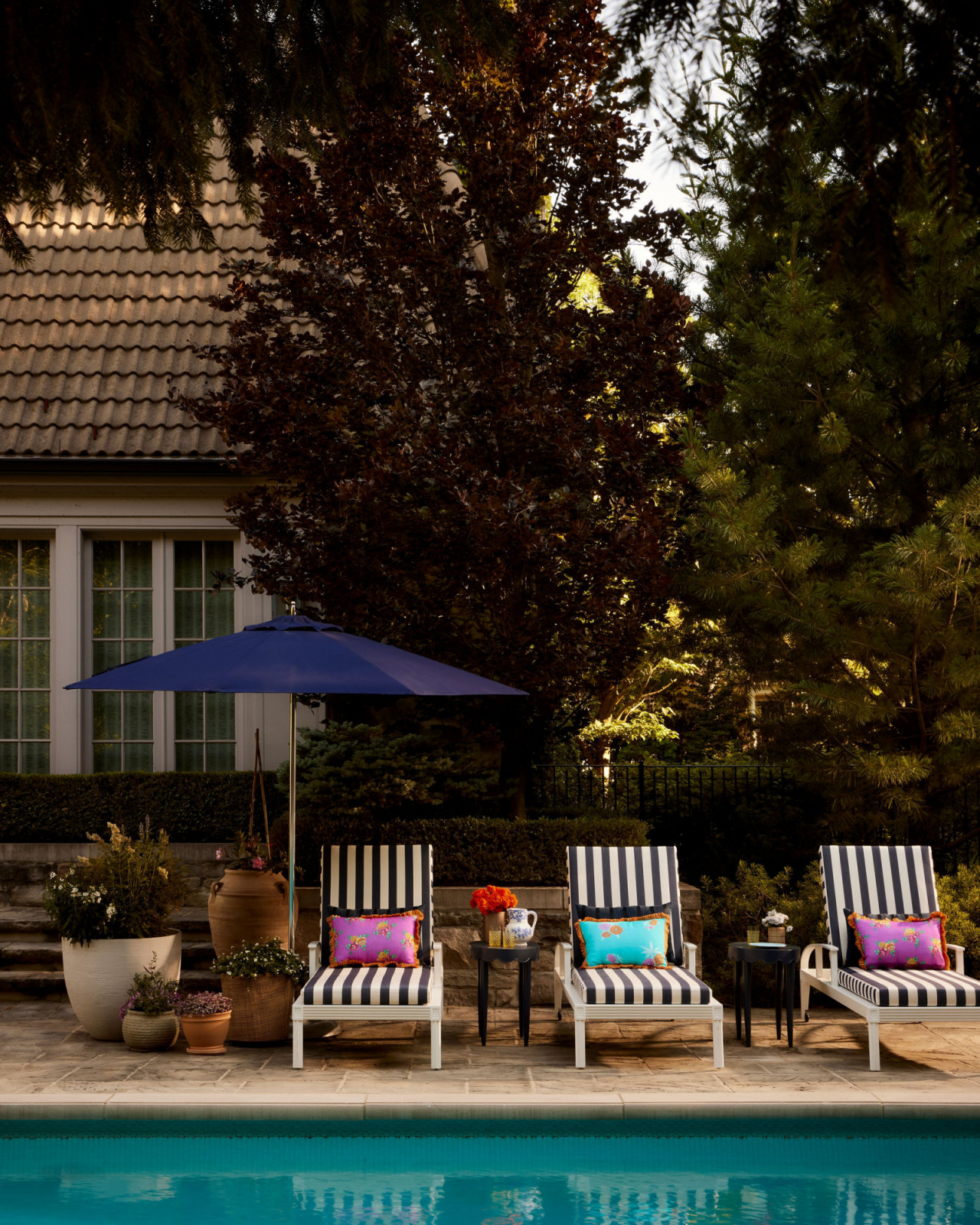 The outdoor pool lounge of an Ontario, Canada mansion renovated by Sabrina Albanese Interiors