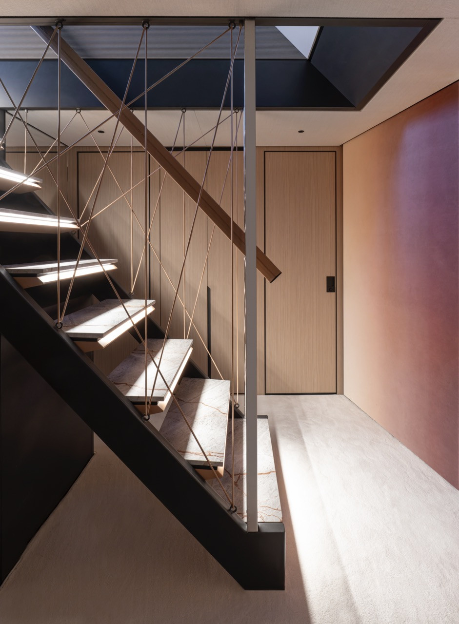 A sculptural staircase with leather detailing anchors circulation through the Azimut Grande 36M interior