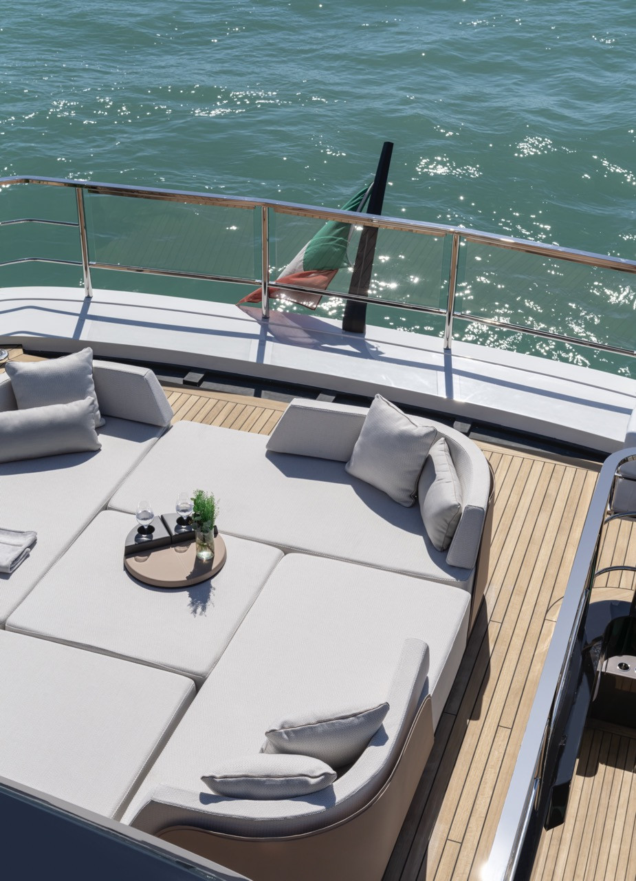 Modular outdoor seating with teak accents lines the Azimut Grande 36M upper deck