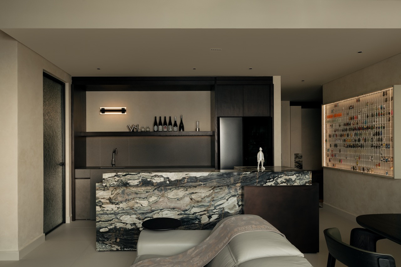 The kitchen island, clad in jade green marble and Italian quartz, serves as one of the main focal points of the Kuala Lumpur apartment