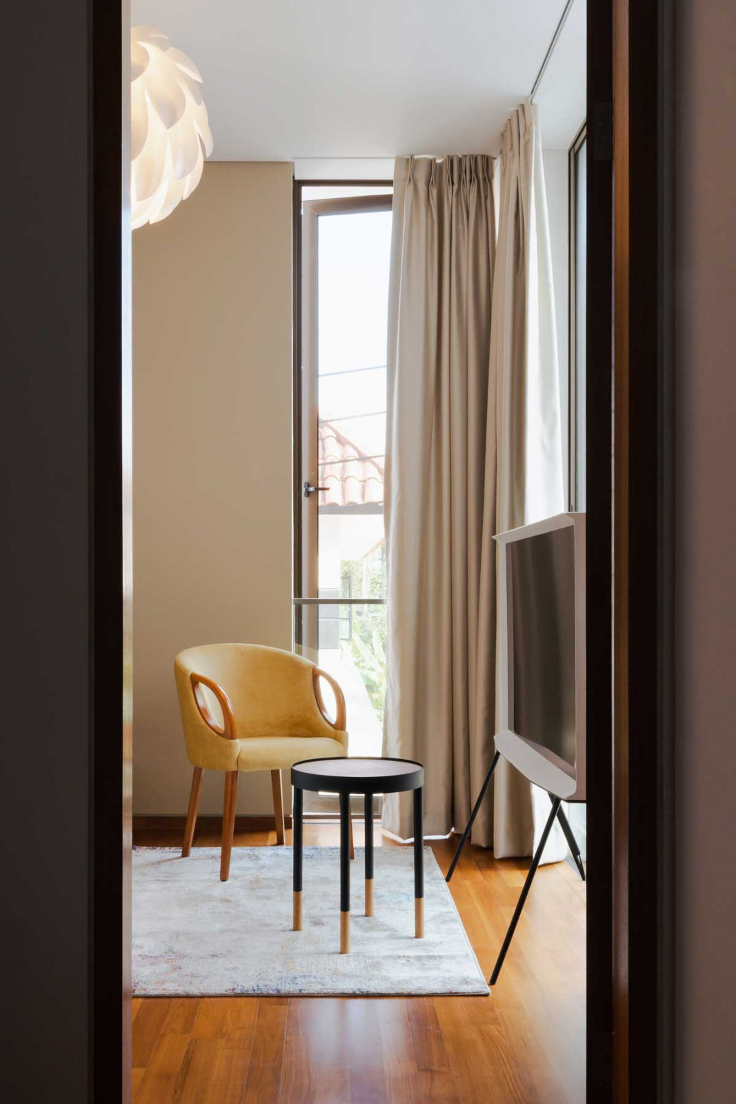 This cosy nook is adorned with a Normann Copenhagen Norm 12 pendant light and Samsung Serif TV