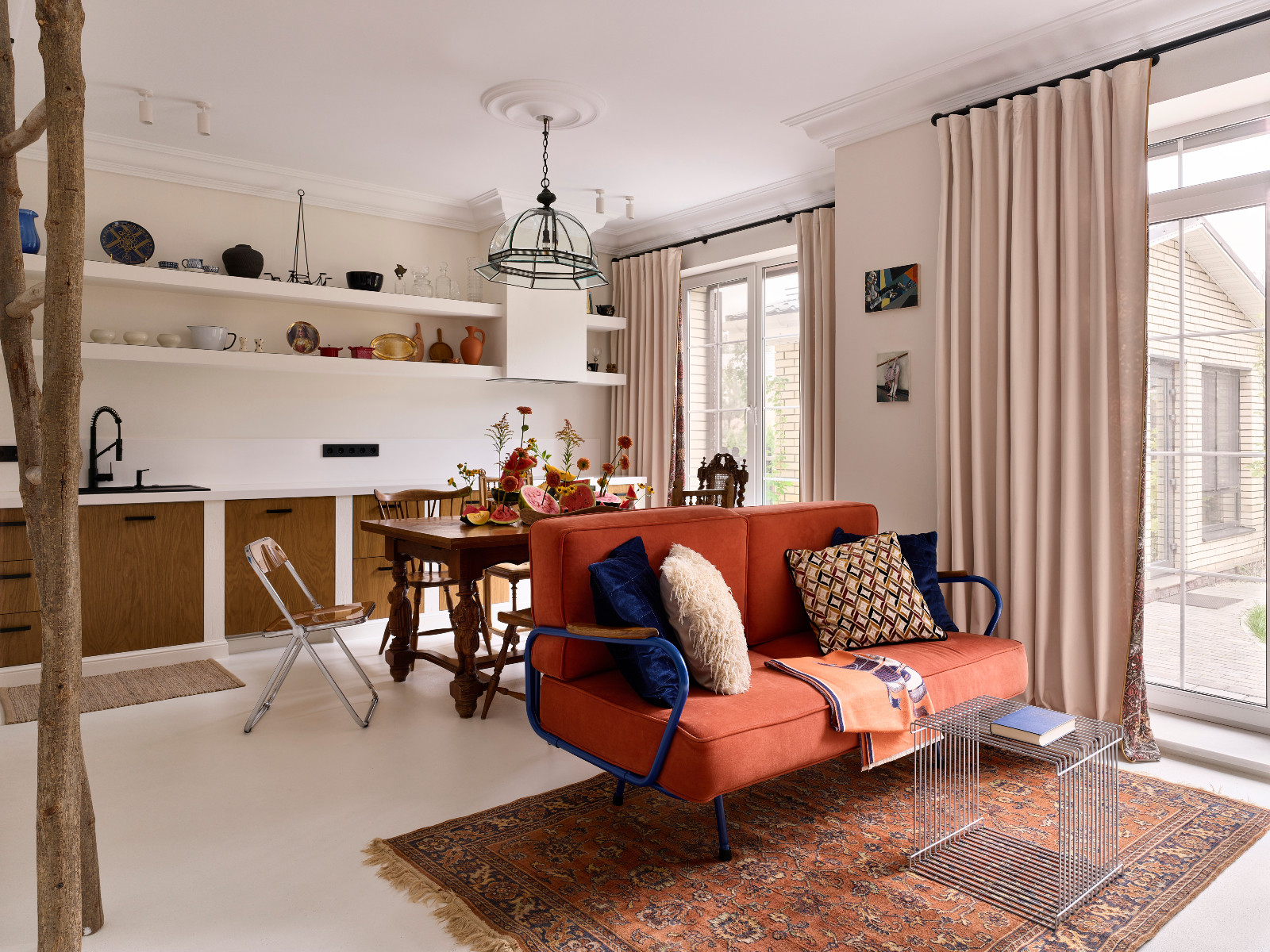 The living room, dining table and kitchen area of Sara Mikhailova's Moscow, Russia home