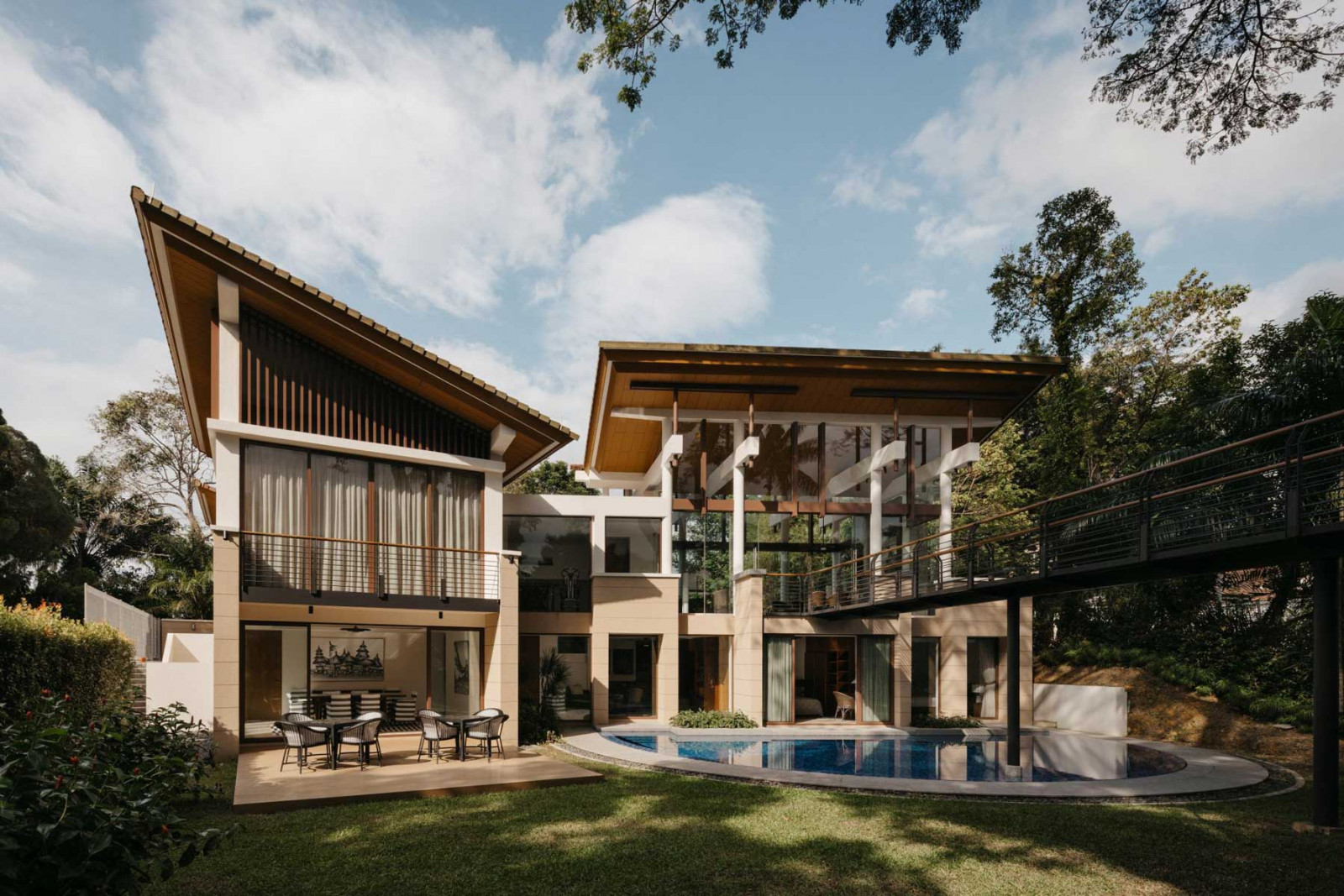 The Good Class Bungalow’s rear facade is articulated with the elegance of a luxury villa with a semi-circular swimming pool designed to create a softer interface with the greenery