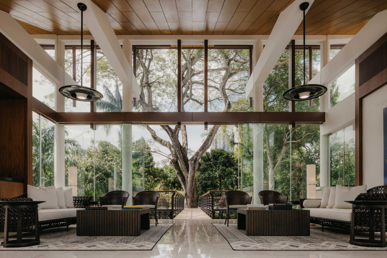 The majestic raintree anchors the stunning view through the Good Class Bungalow’s glazed living area