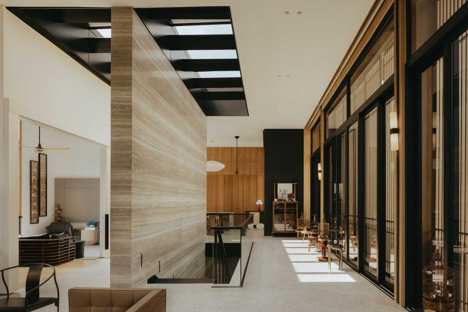 The light-toned timber facade provides a dynamic counterpoint to the dark finishes of the Good Class Bungalow’s interior