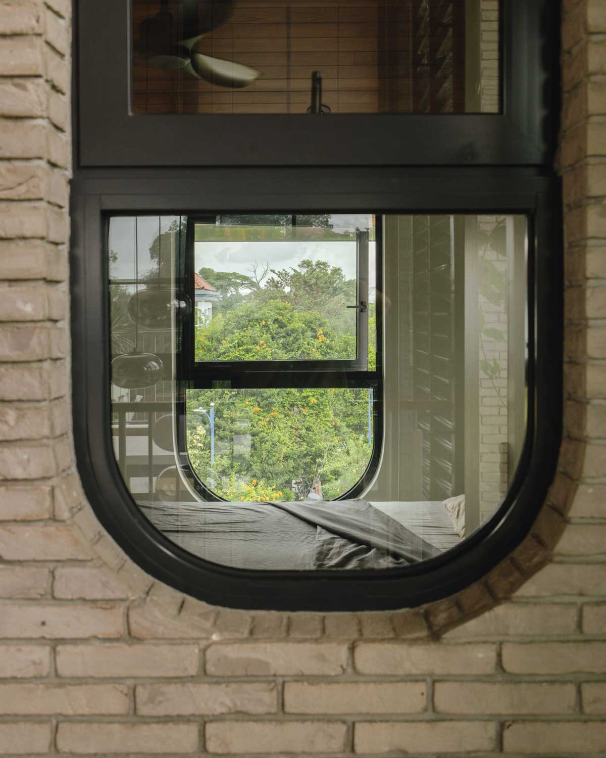 A peek at the home’s lush surroundings through the guest suite window