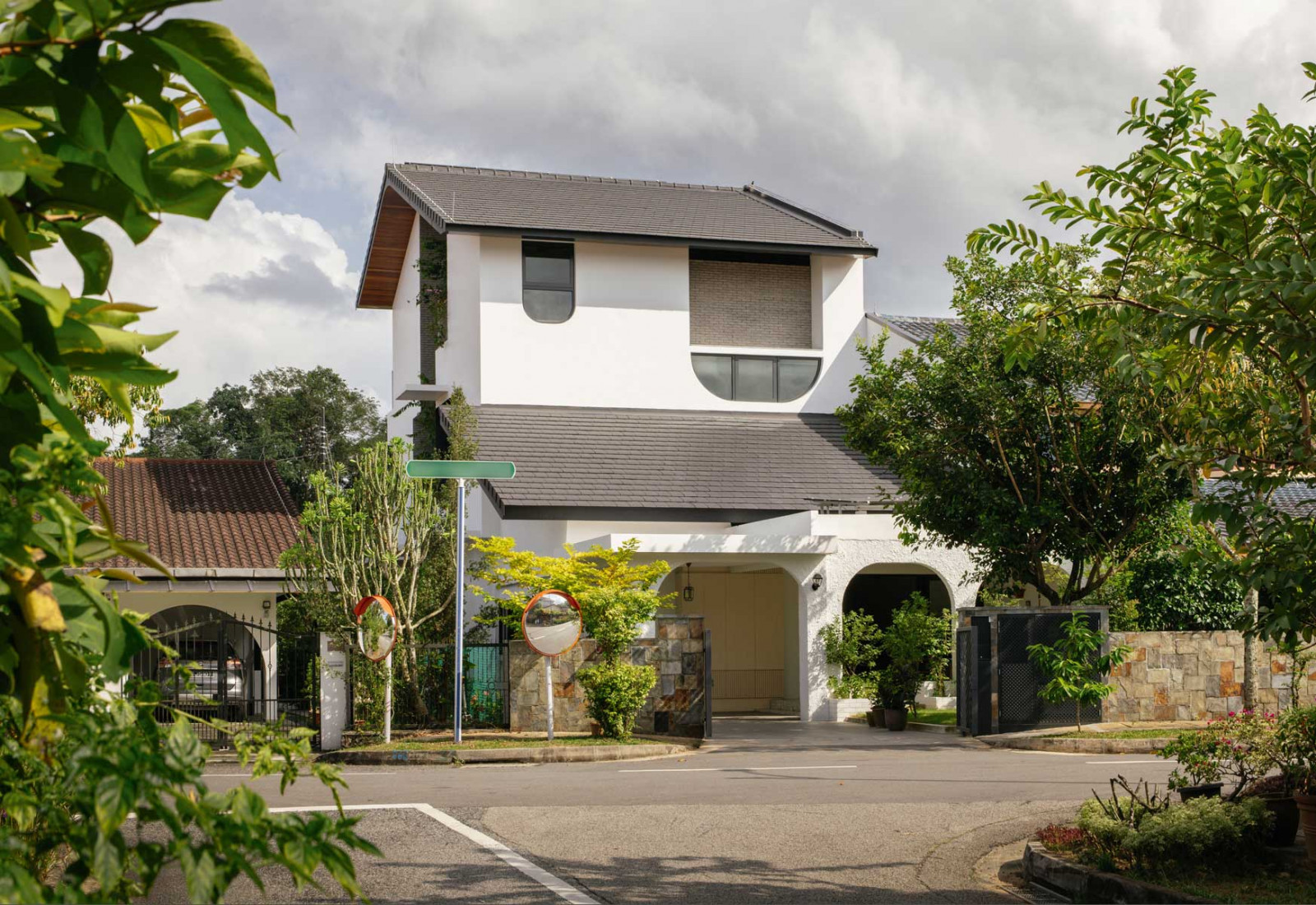 Grey brick slips impart tactility and a modern aesthetic to the facade of the home