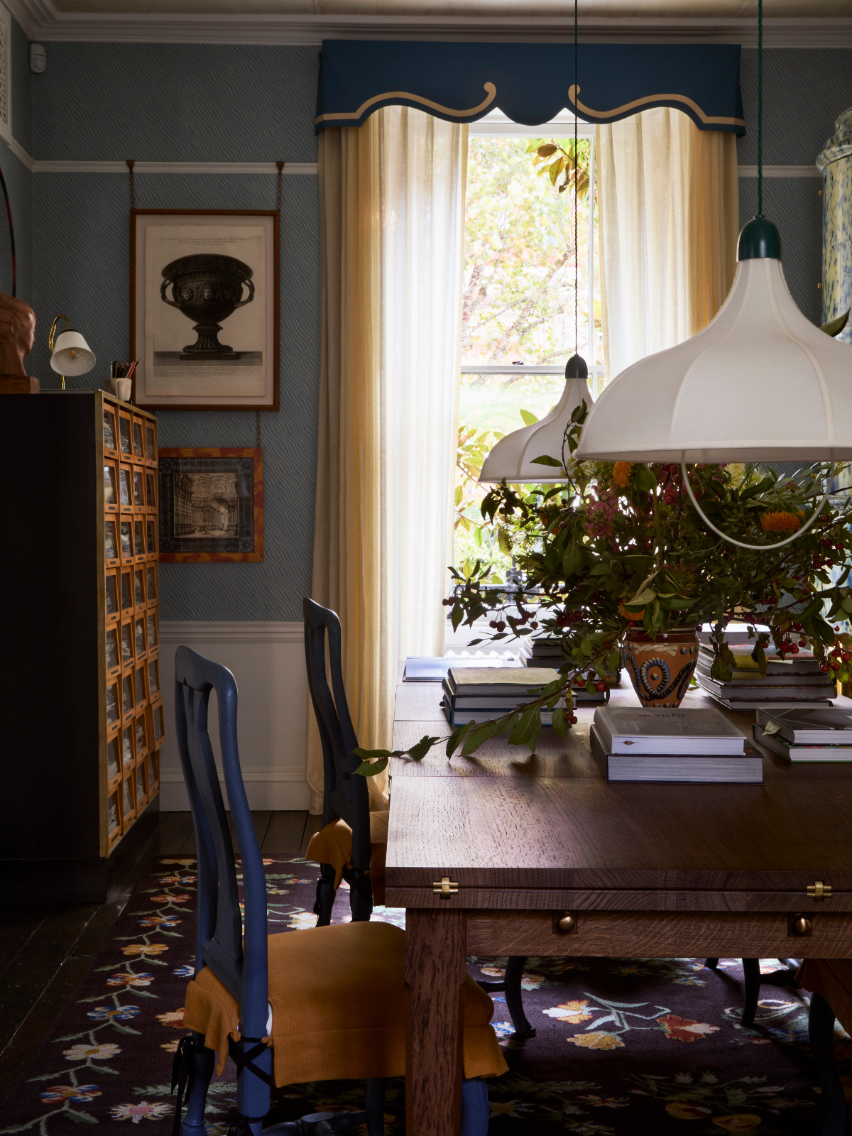 A melange of blues and yellows plays in Beata Heuman's dining room, punctuated by a pair of white pendant lamps