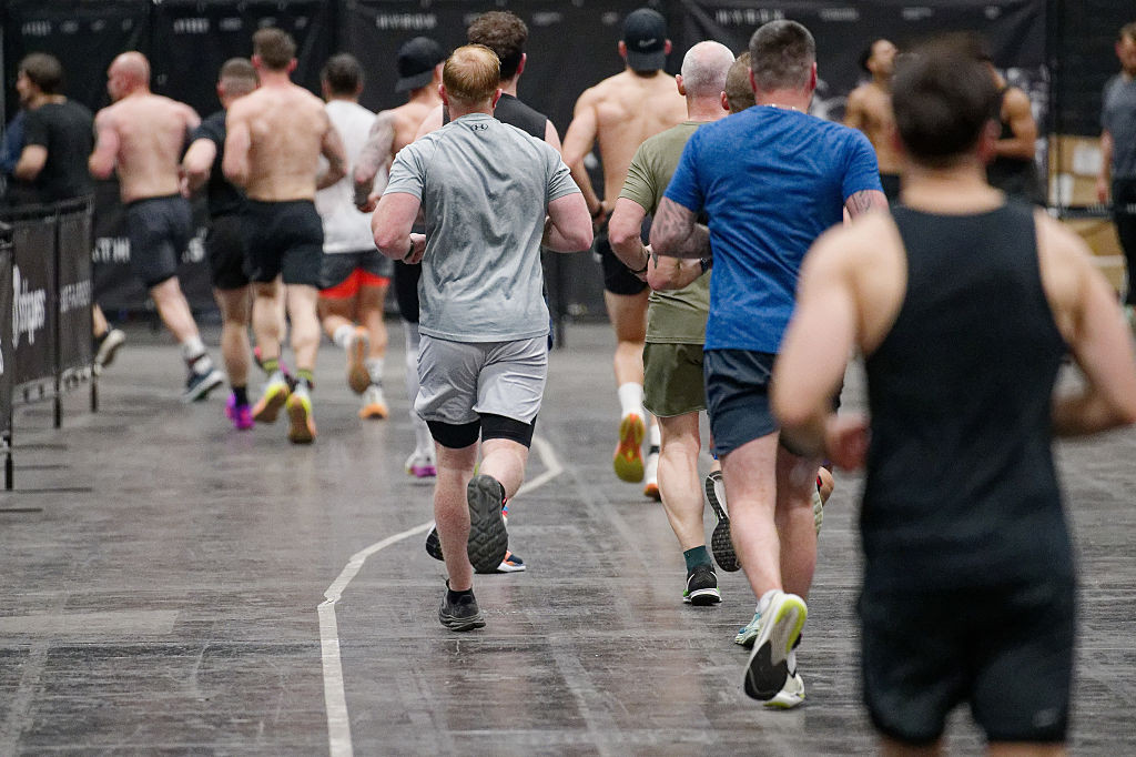 10 April 2025, North Rhine-Westphalia, Cologne: Participants run through a hall in a HYDROX competition at the "Fibo 2025" fitness trade fair. HYROX is part of indoor fitness and combines eight kilometers of running with eight functional workout stations. The trade fair presents new trends in fitness, wellness and health to trade visitors and consumers. Photo: Henning Kaiser/dpa (Photo by Henning Kaiser/picture alliance via Getty Images)
