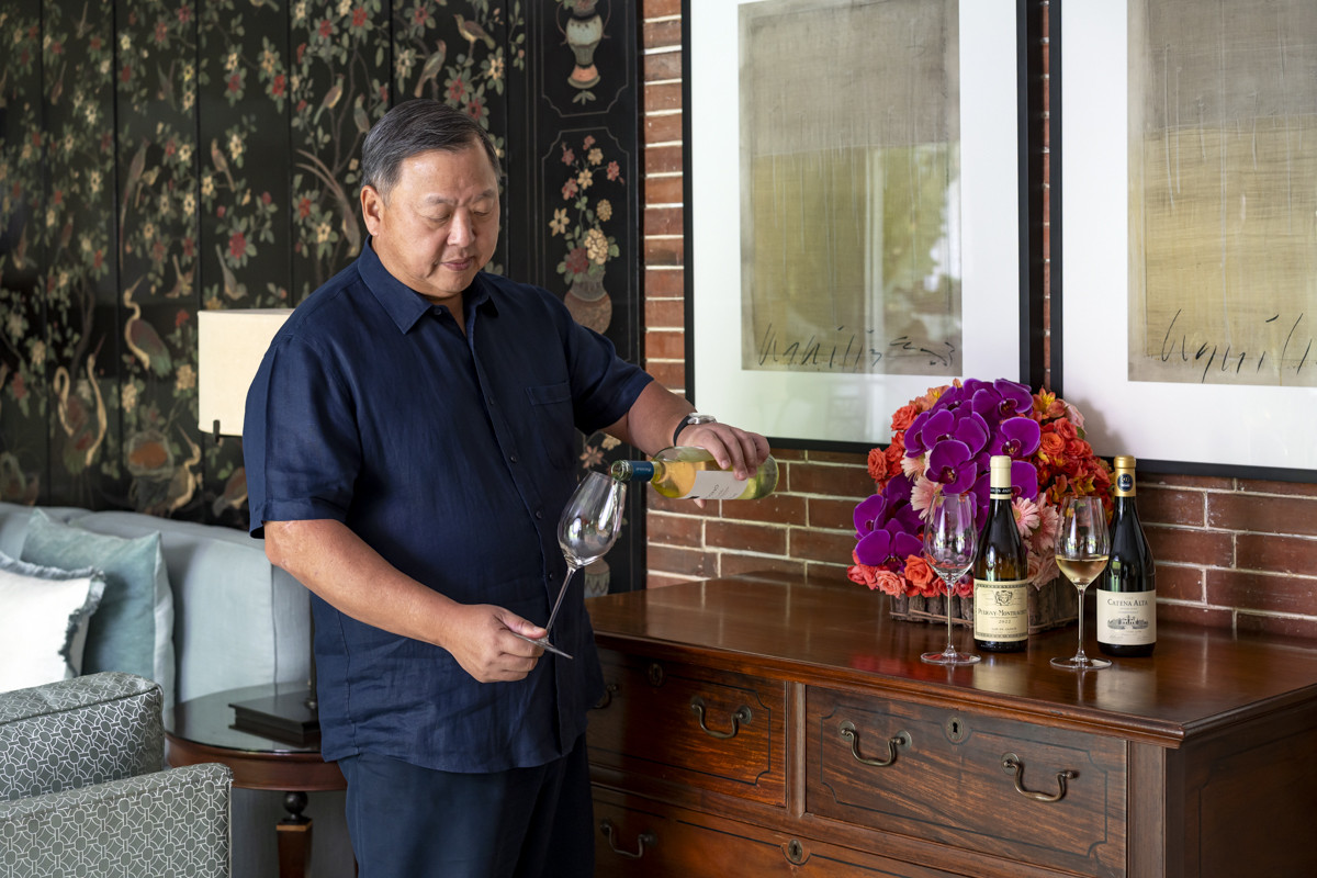 Alex Lichaytoo pouring a glass of wine at home