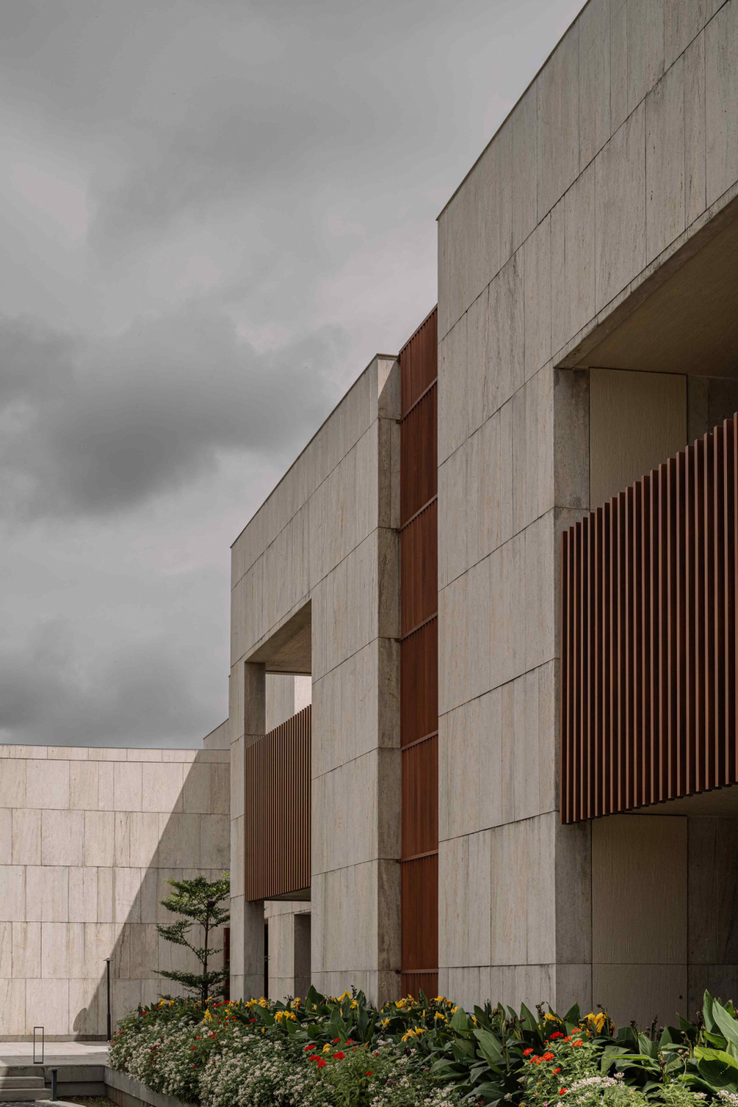 Wood accents break the monotonous palette of the façade