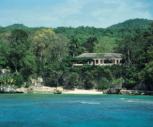 Ian Fleming’s Goldeneye estate in Oracabessa, Jamaica, photographed from the beach. Fleming designed the three-bedroom house himself in 1946 with jalousie shutters instead of windows to capture the Caribbean breeze
