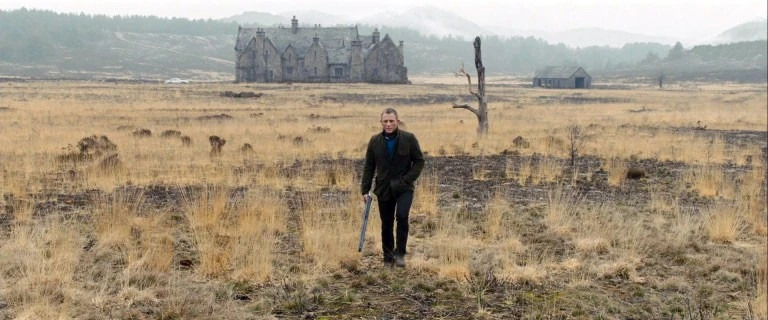 Wide view of Skyfall Lodge before its destruction. Seventy craftsmen constructed the set over several weeks. The Scottish baronial aesthetic influenced interior design trends between 2012 and 2015