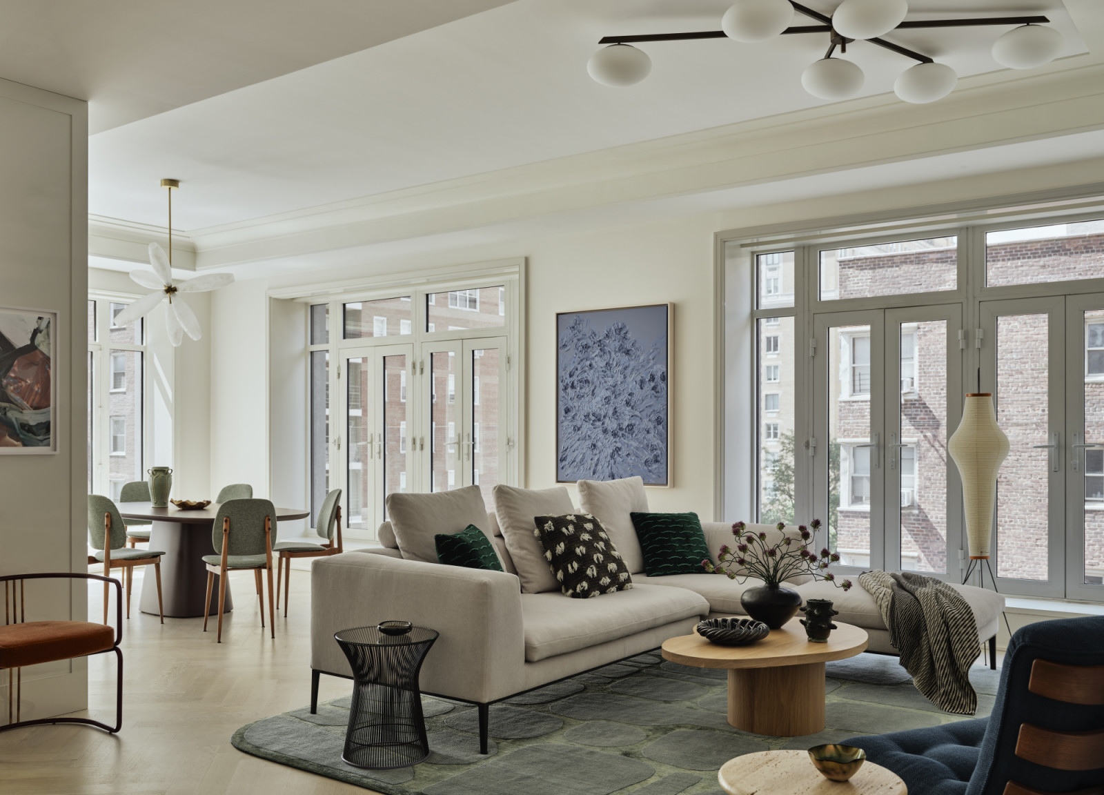 The living room and dining area in a New York apartment, designed by Lucy Harris