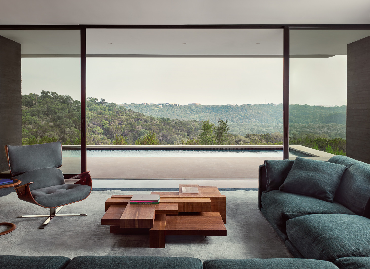 The living room overlooking the pool area of an Austin, Texas home designed by Alterstudio Architects