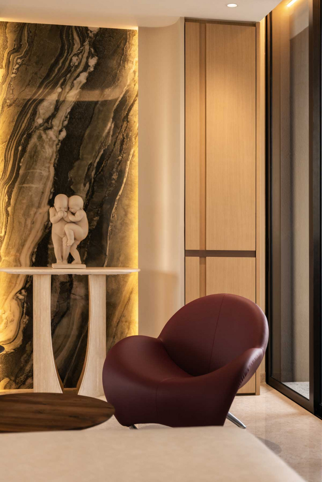 A vintage chair fronts a vignette of artworks and textured finishes