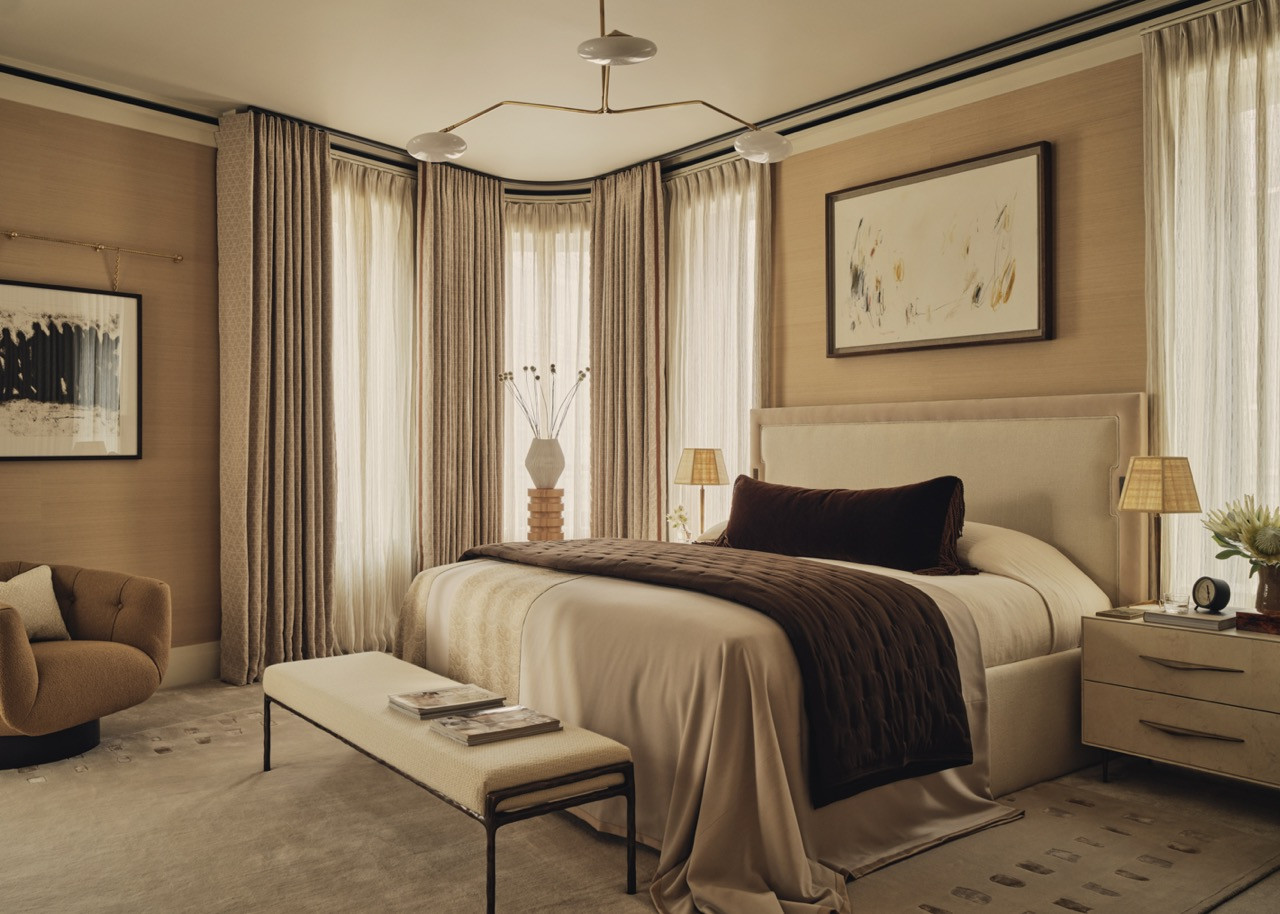 The principal bedroom is defined by its curved window overlooking the Gustafson Porter + Bowman courtyard garden, featuring a bespoke emperor bed by Robert Langford