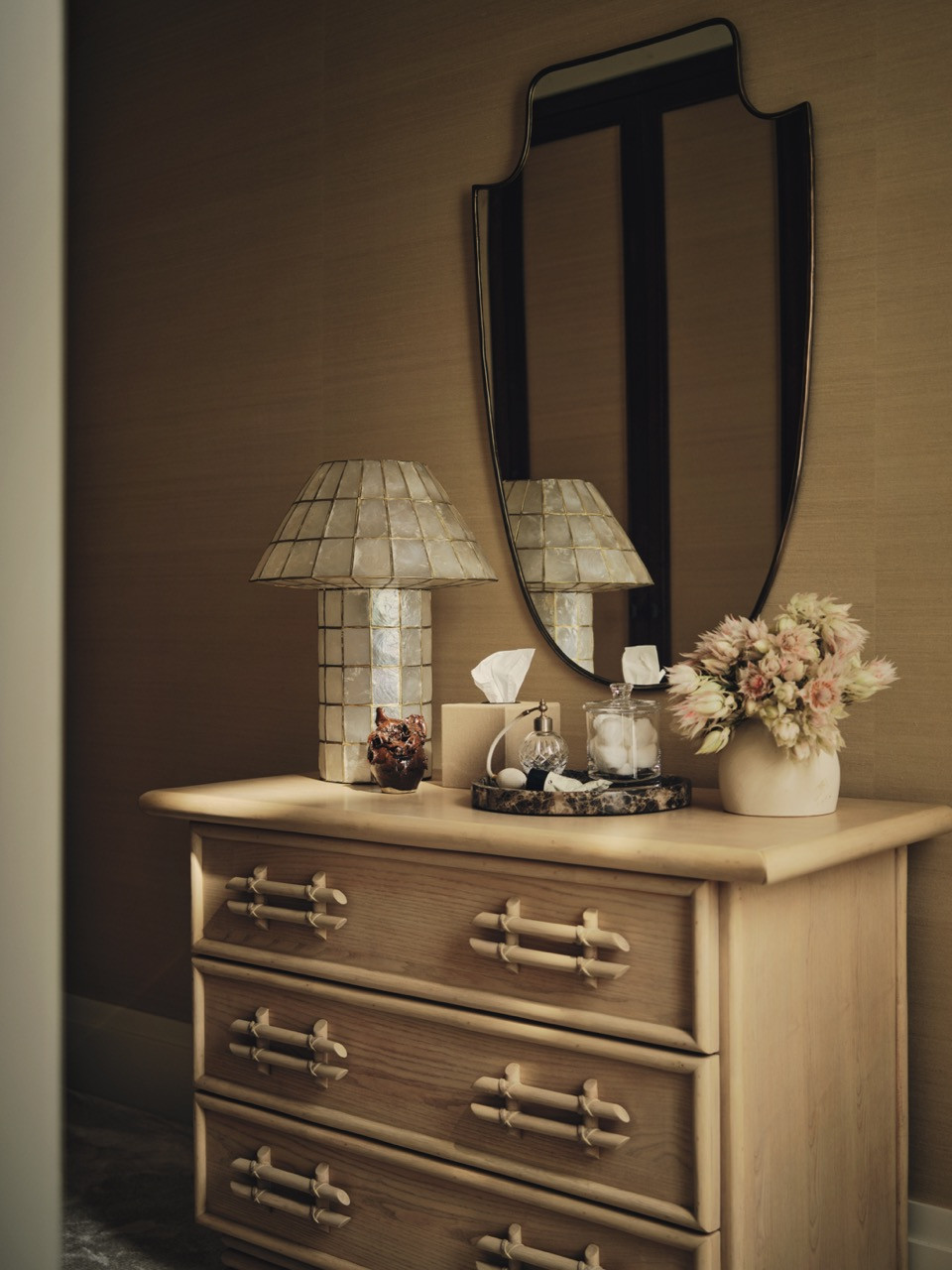 A bedroom detail showing timber furniture with decorative mother-of-pearl lamps