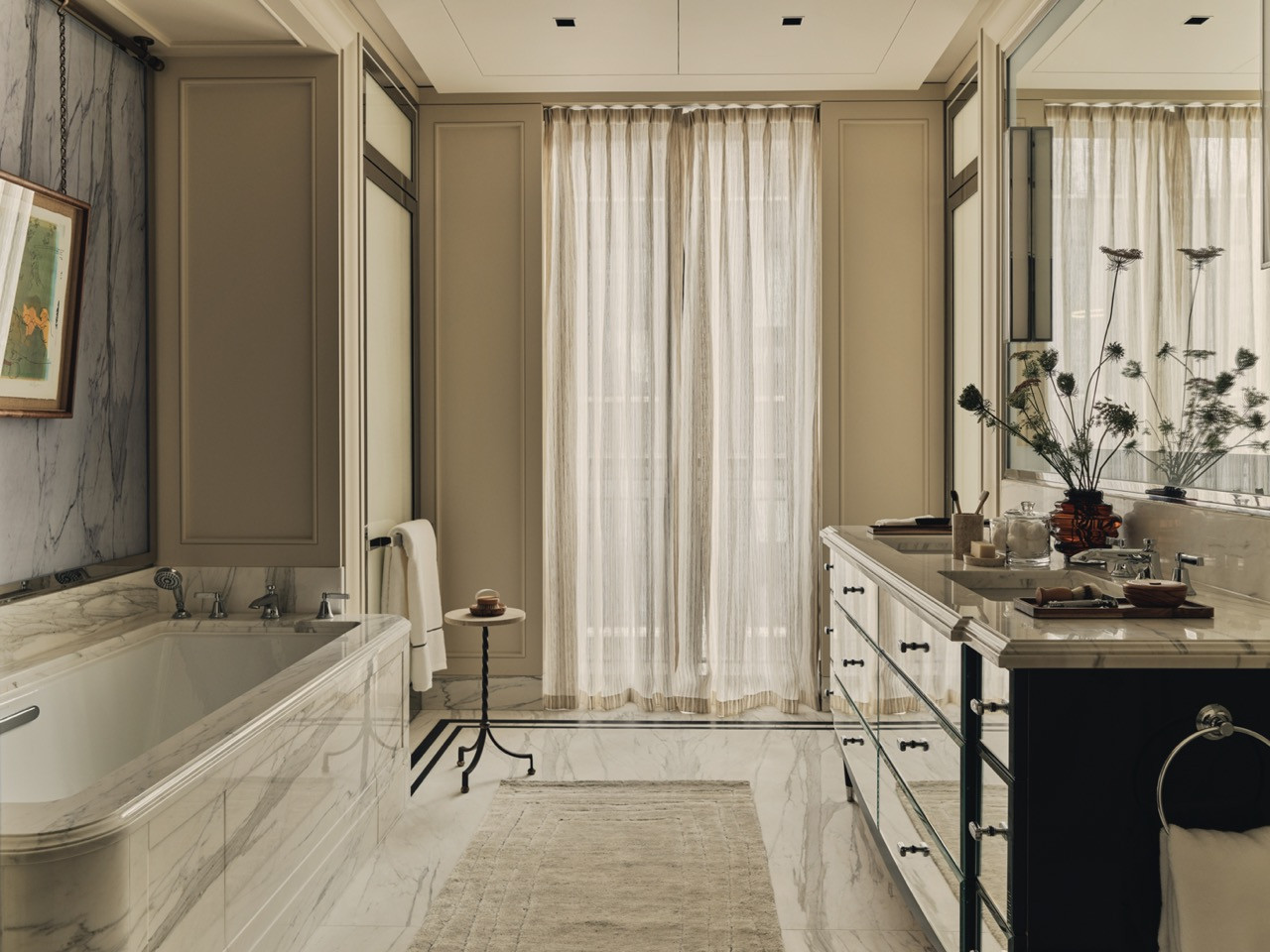The principal bathroom with marble finishes and panelled walls