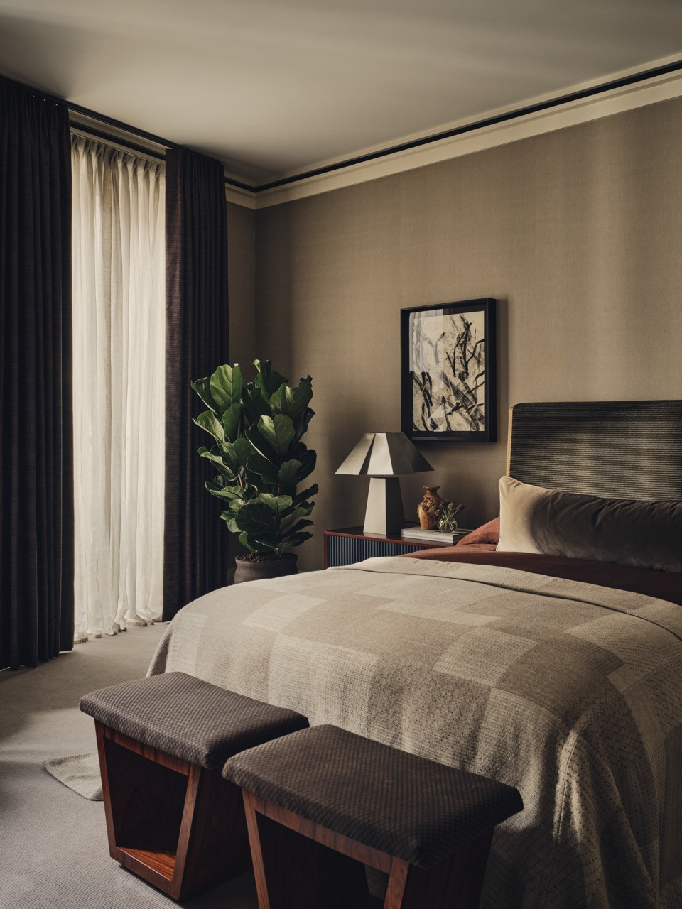 A bedroom view showing darker flooring that creates visual transitions between spaces