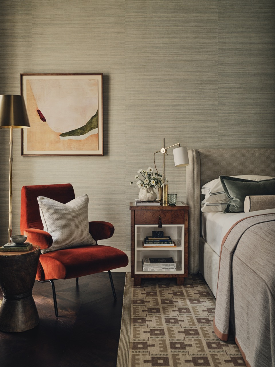 One of the additional bedrooms has a terracotta-toned armchair, introducing warmer tones to the palette