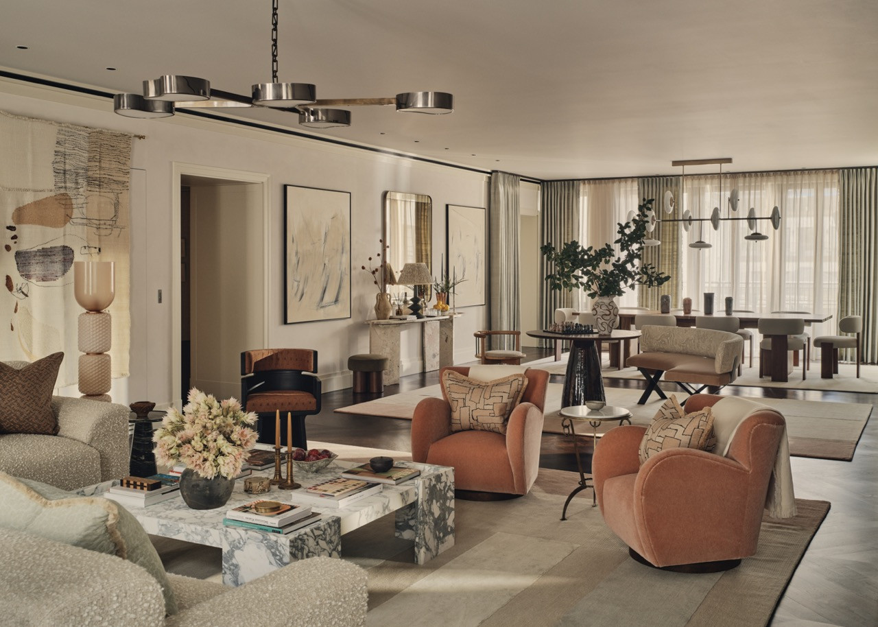 Multiple seating arrangements within the living room, including terracotta-toned armchairs
