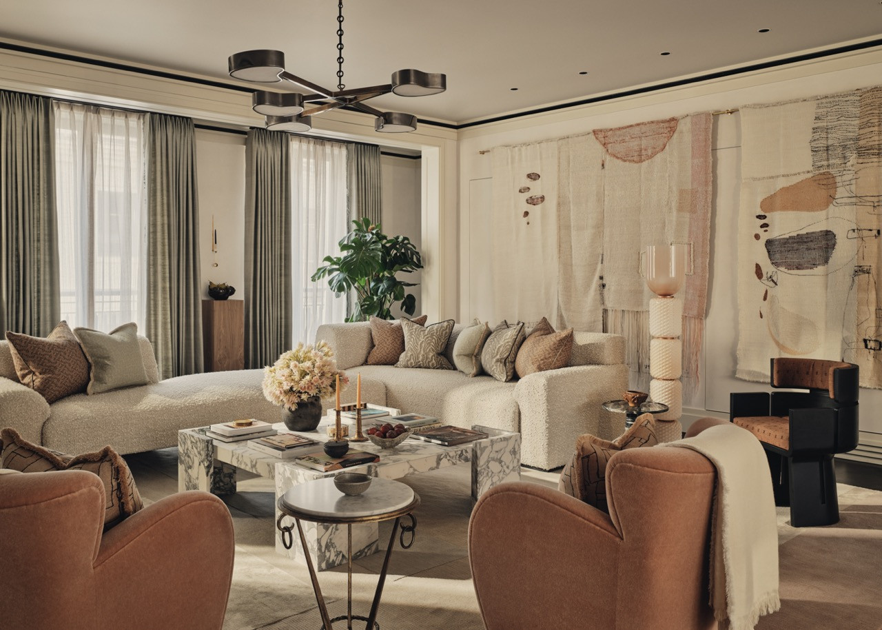 The open-plan living space unfolds across three zones with layered rugs defining each area