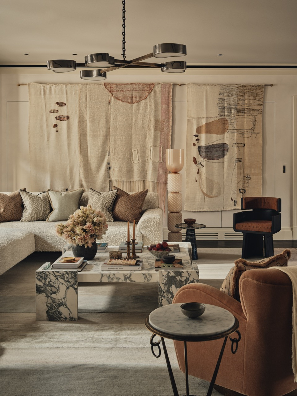 The living room shows the bespoke boucle sofa beneath an Italian Gaspare Asaro pendant light