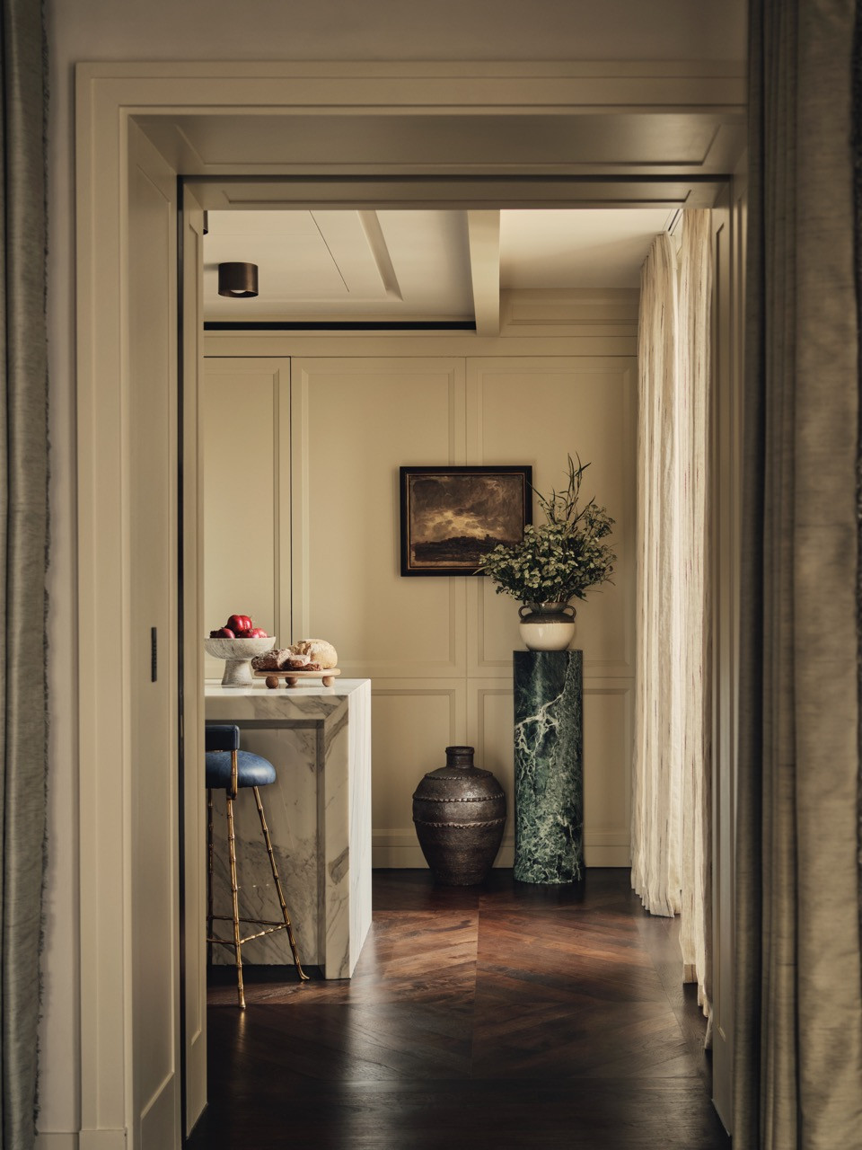 A view showing the connection between spaces, with darker wood flooring in select rooms creating visual transitions
